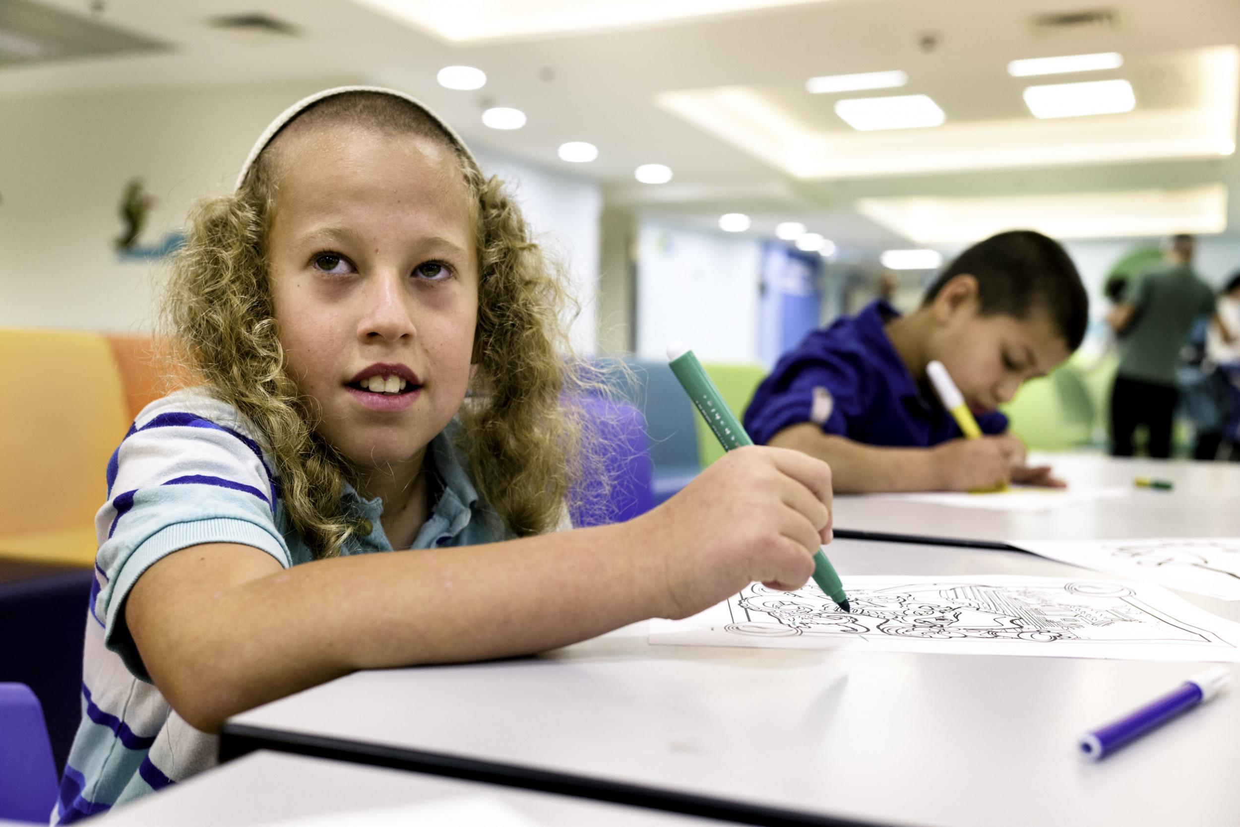 An Israeli and Arab boy in Shaare Zedek with their families