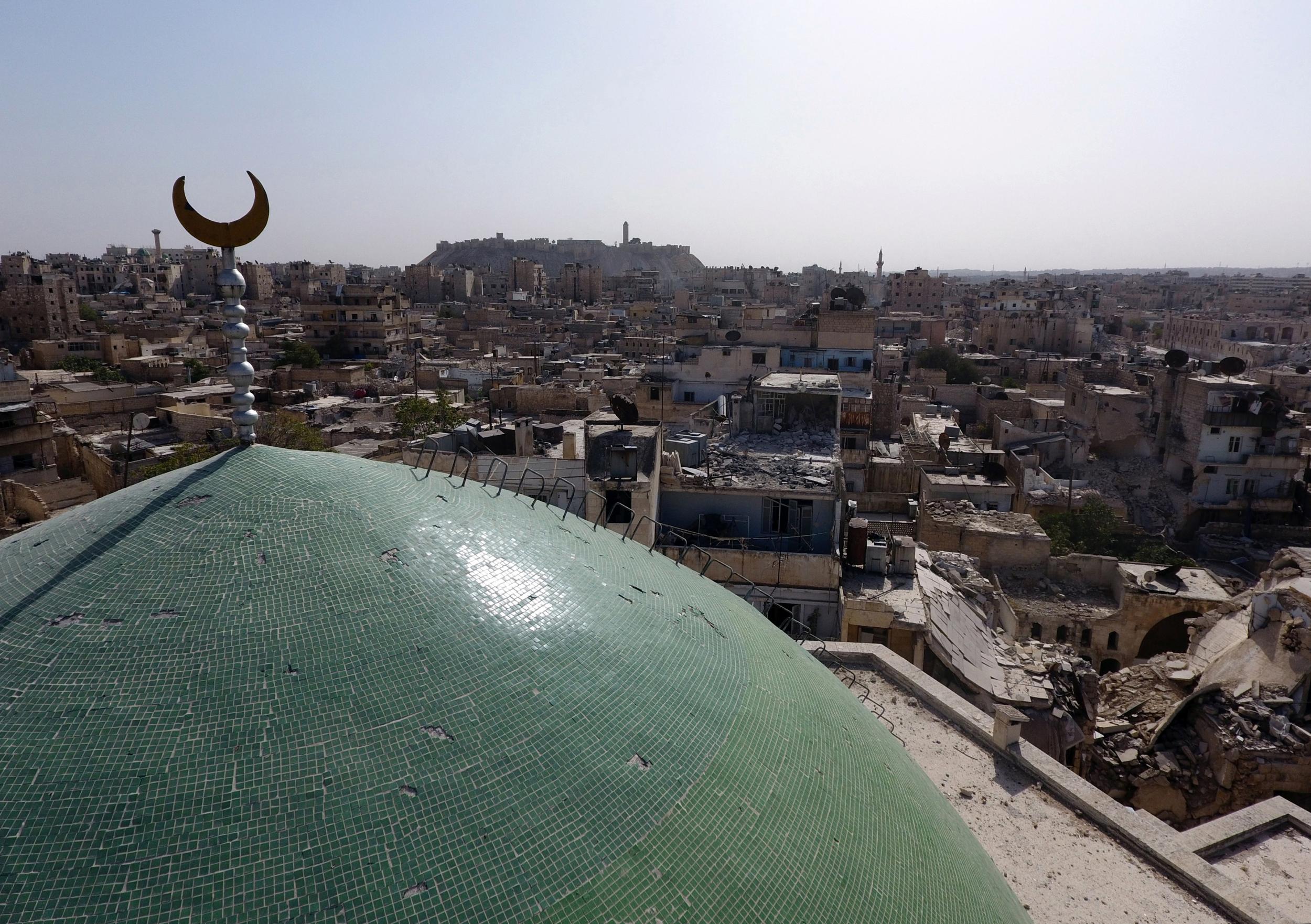 Drone view of the minaret of the historic Osama Bin Zayed mosque along with buildings damaged by years of air strikes in the old city of Aleppo, Syria, taken on October 13, 2016