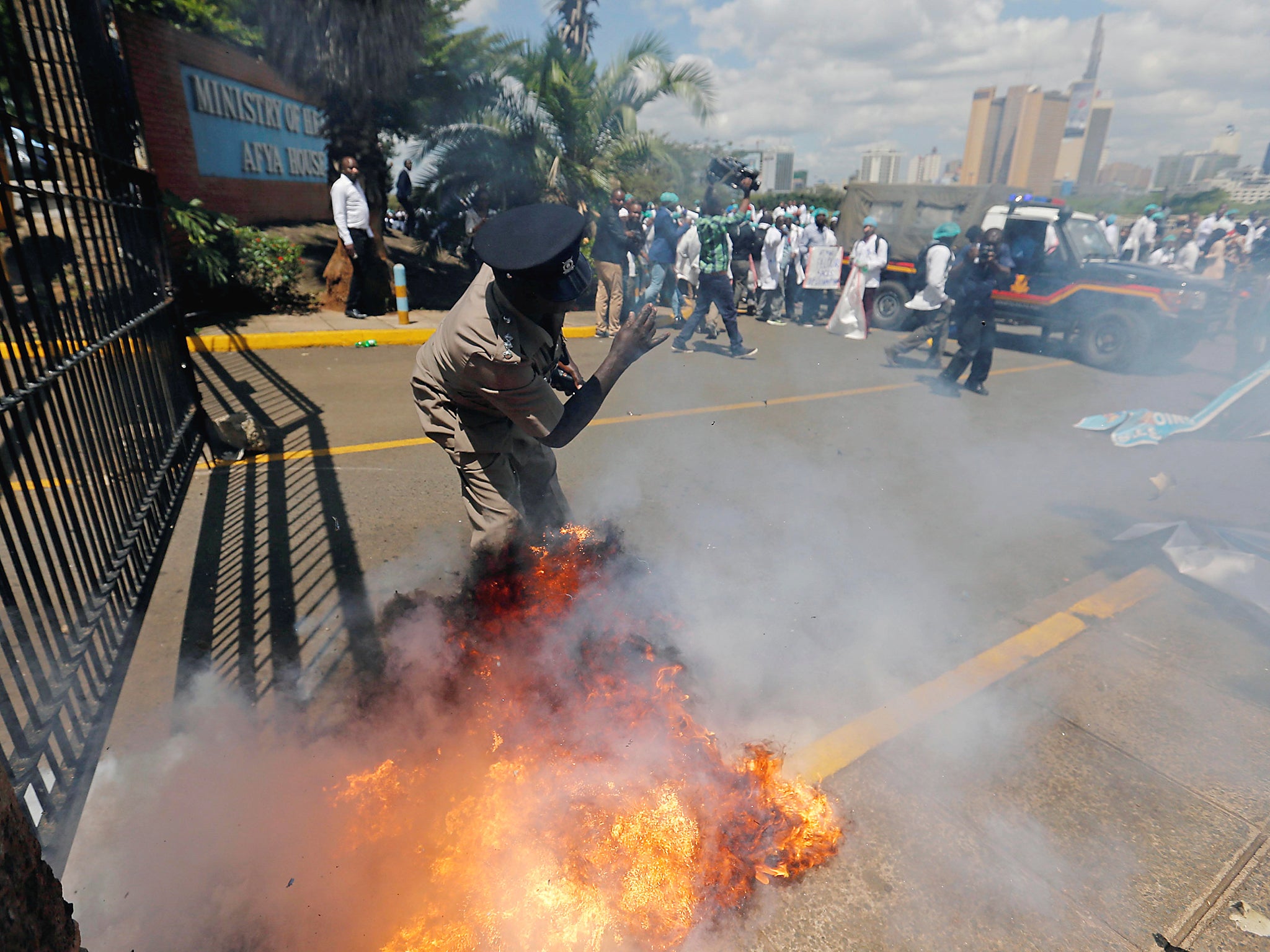 &#13;
A tear gas canister fired by riot police explodes near a policeman as doctors strike to demand fulfilment of a 2013 agreement between their union and the government that would raise their pay and improve working conditions &#13;