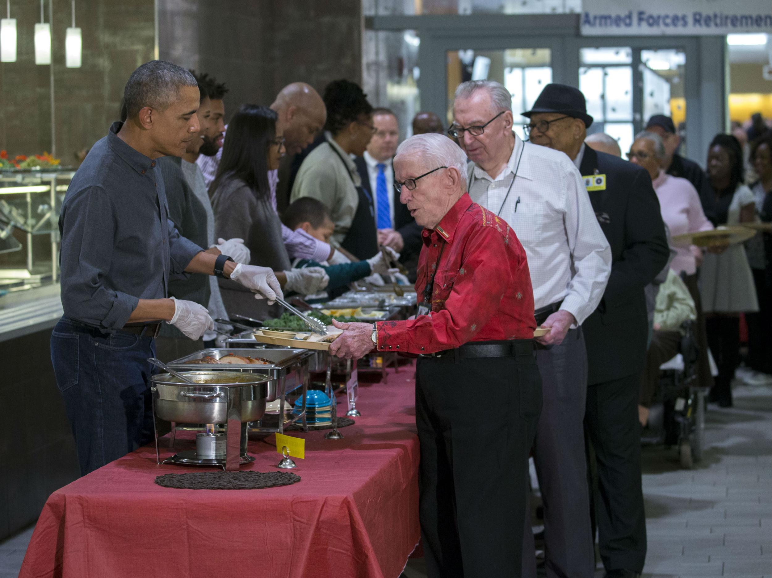 President Barack Obama serves Thanksgiving dinner to residents at the Armed Forces Retirement Home on 23 November 23 in Washington DC