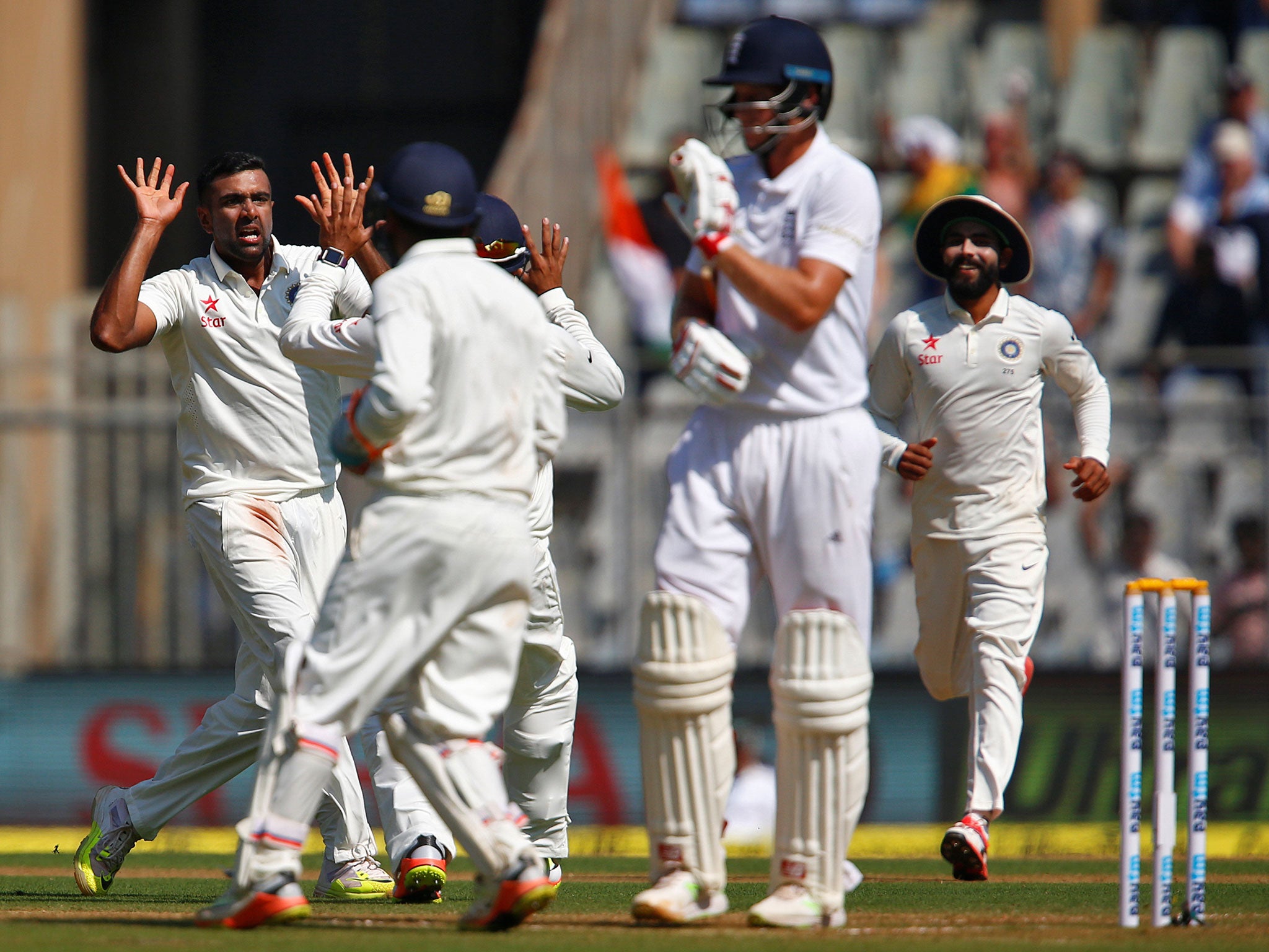 Ravichandran Ashwin celebrates with team mates after Joe Root was caught by India's captain Virat Kohli
