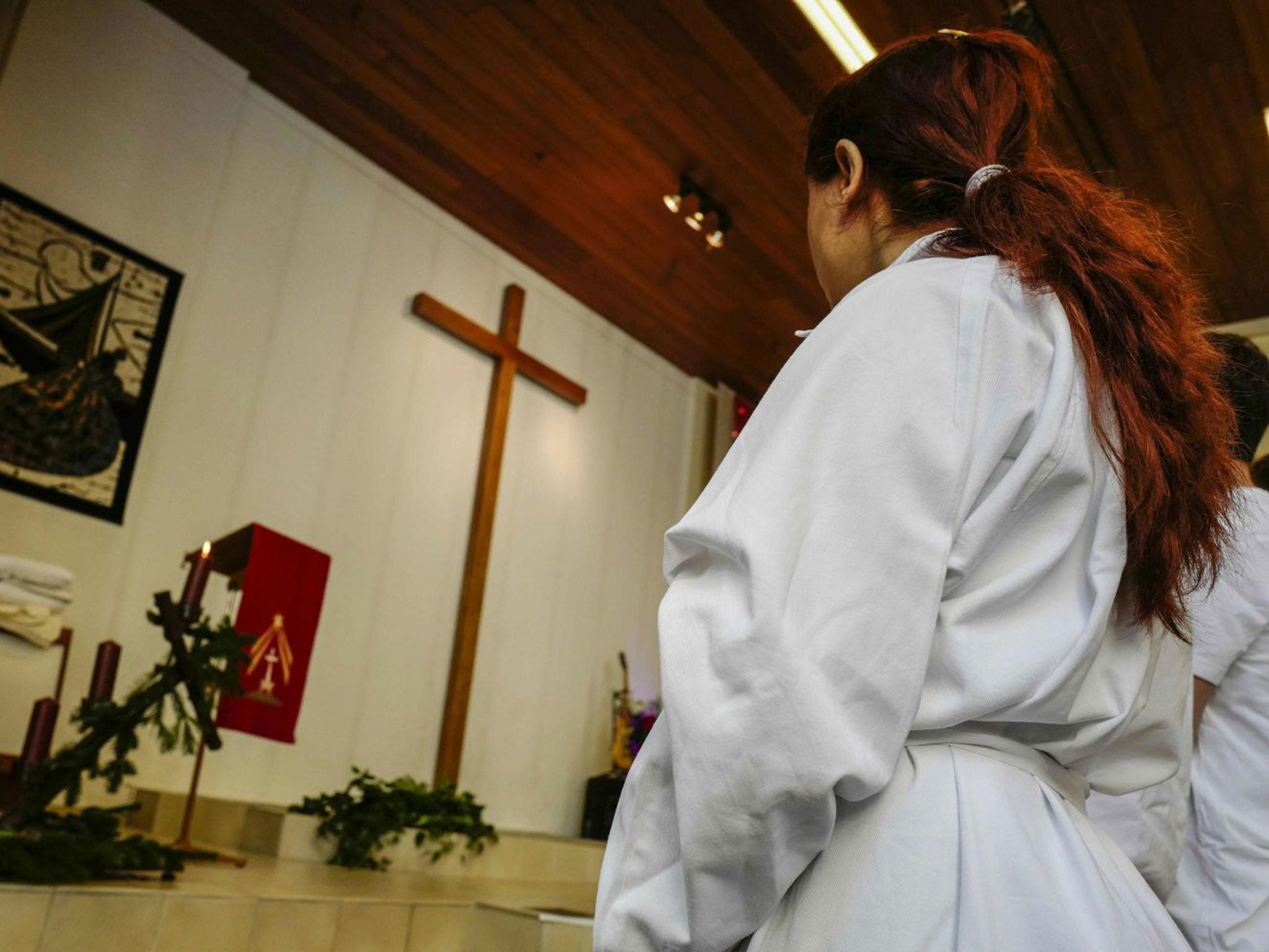 One of four newly-converted Muslim refugees attends a Baptism ceremony at the Evangelisch-Freikirchliche Gemeinde church in Berlin on 27 November