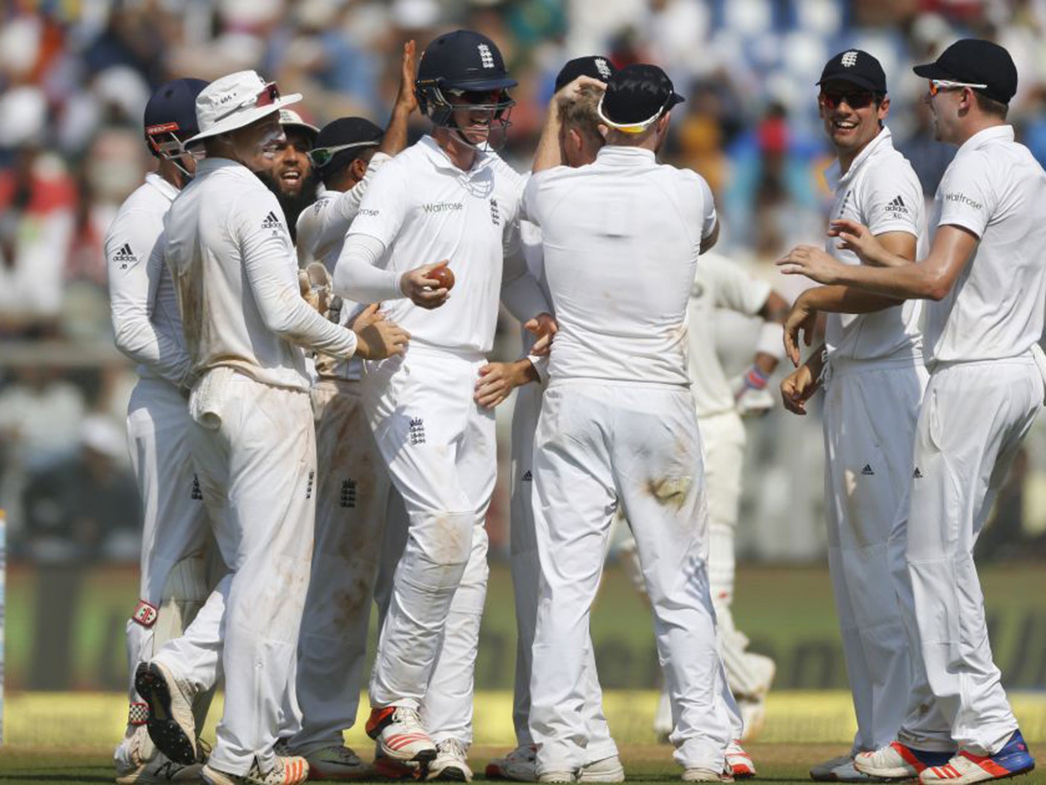 England's players celebrating the wicket of Ashwin, one of six to fall on Saturday