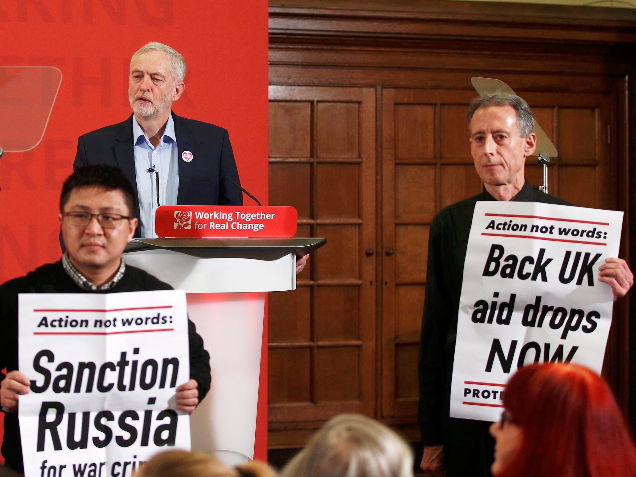 Peter Tatchell (right) leads protesters disrupting a speech by Jeremy Corbyn to demand more action in Aleppo, in London on 10 December