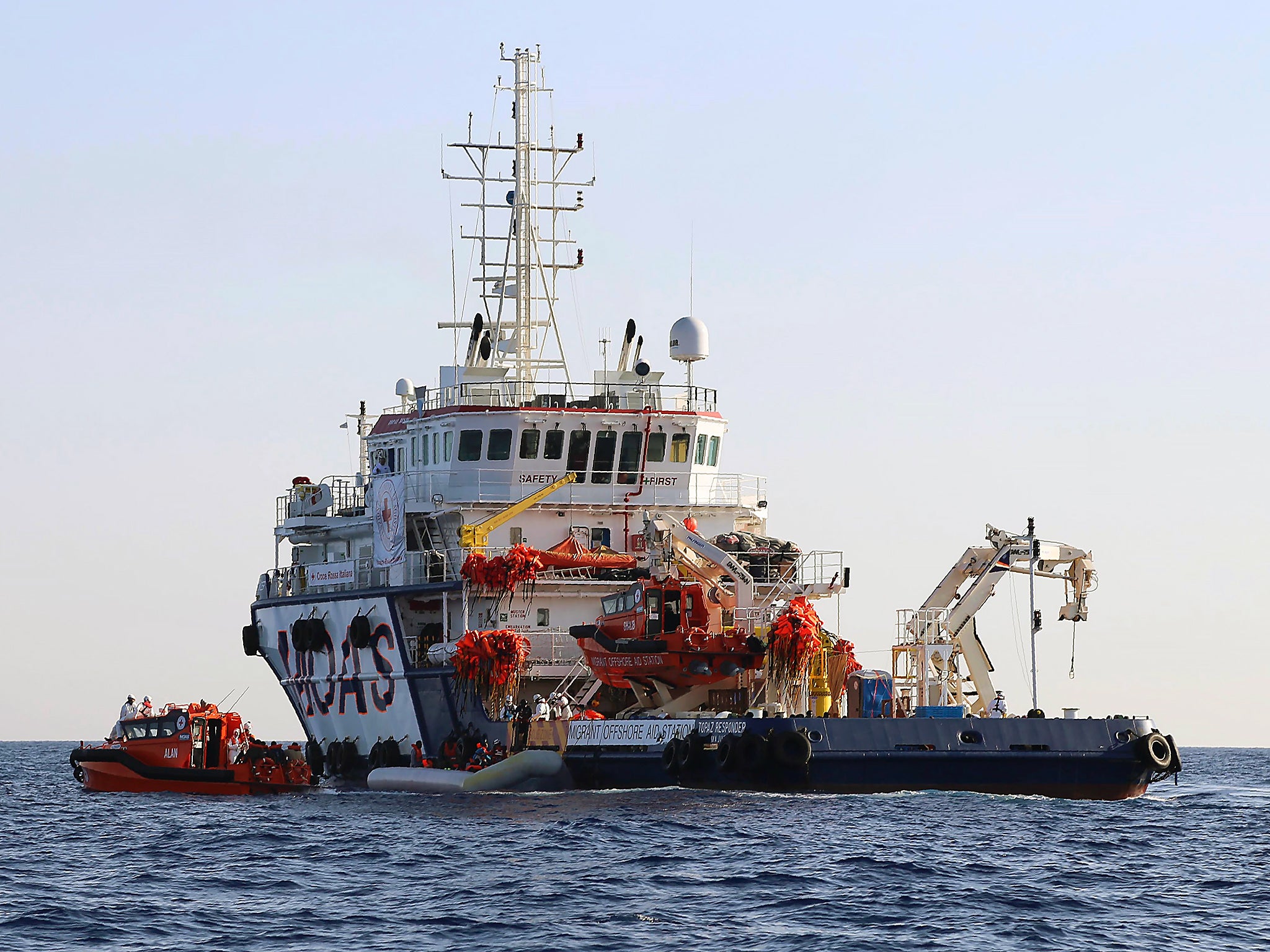 A migrants dingy boat pulled towards an aid ship during a rescue operation offshore of the western Libyan town of Sabratha