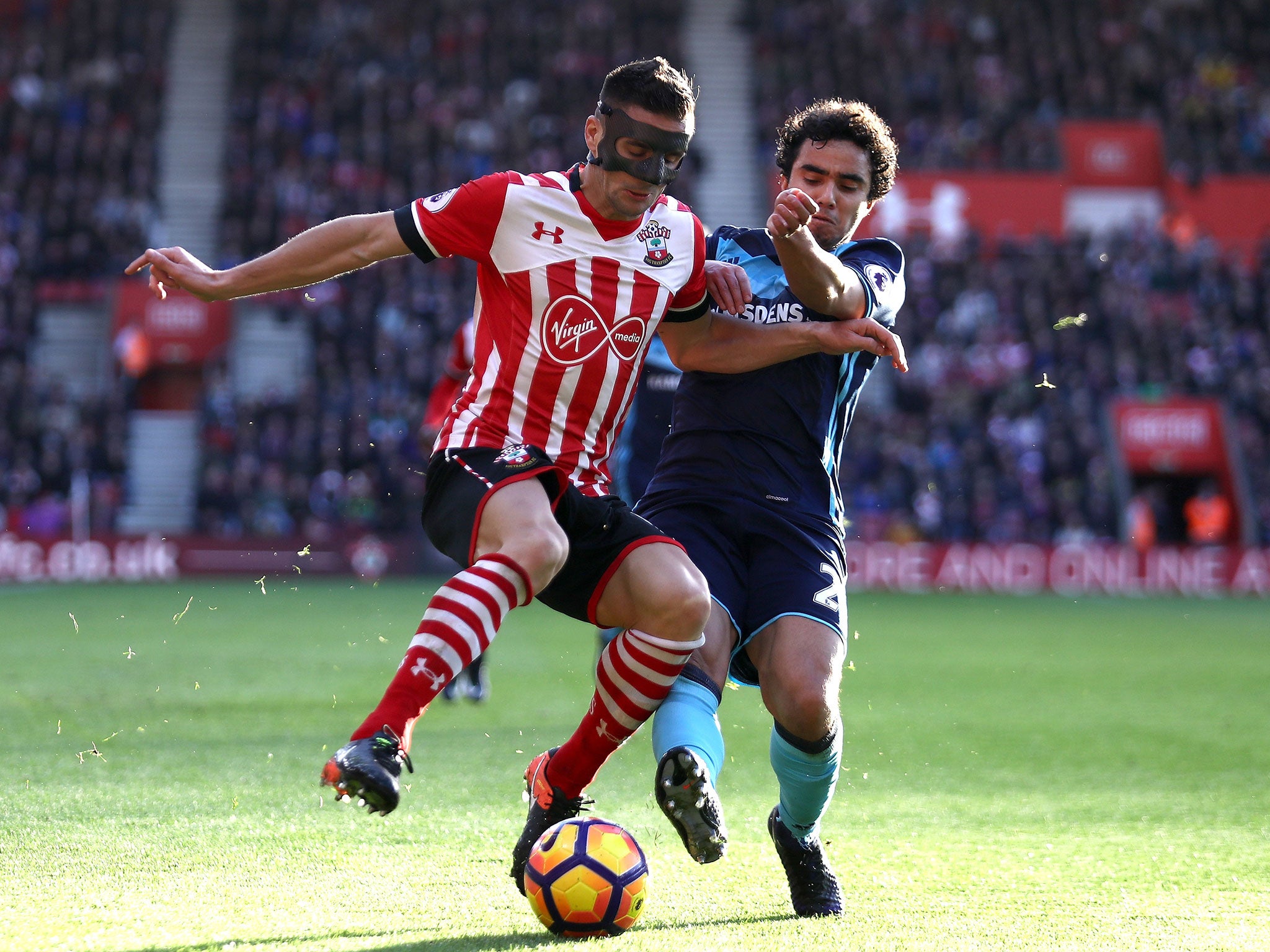 Fabio Da Silva looks to dispossess Dusan Tadic with a challenge