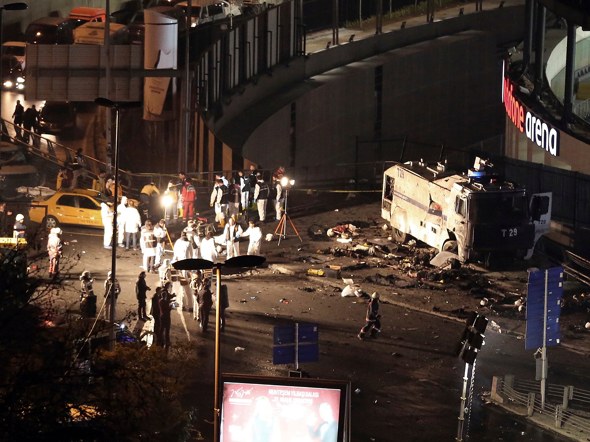 Police forensic officers work after explosions near the Besiktas football club stadium, Vodafone Arena, in Istanbul. Turkey