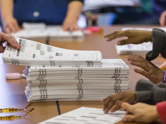 Tabulators work on recounting presidential ballots in Dane County, Wisconsin, in December