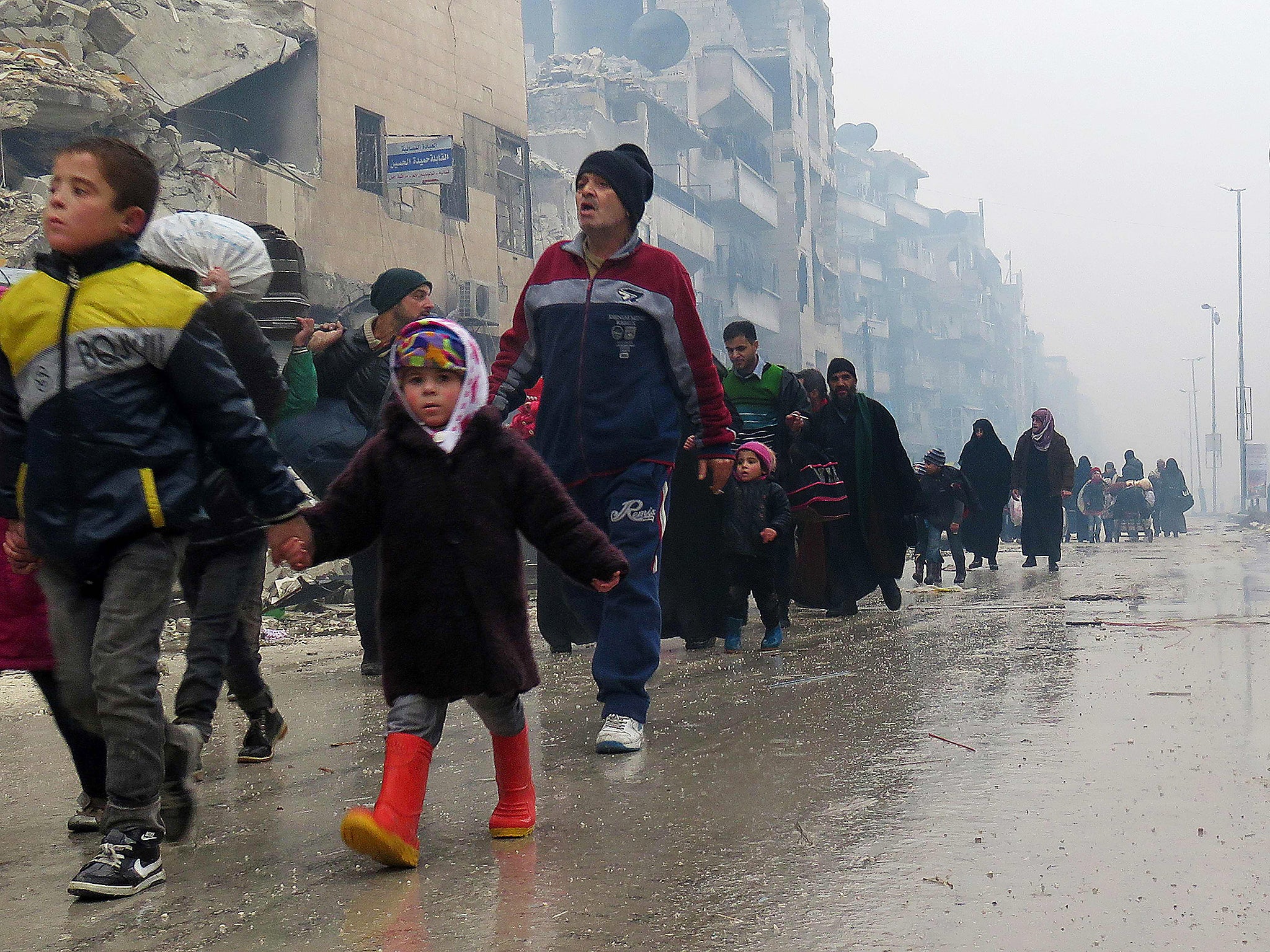 Syrian residents, fleeing violence in the restive Bustan al-Qasr neighbourhood, arrive in Aleppo's Fardos neighbourhood, after regime troops retook the area from rebel fighters