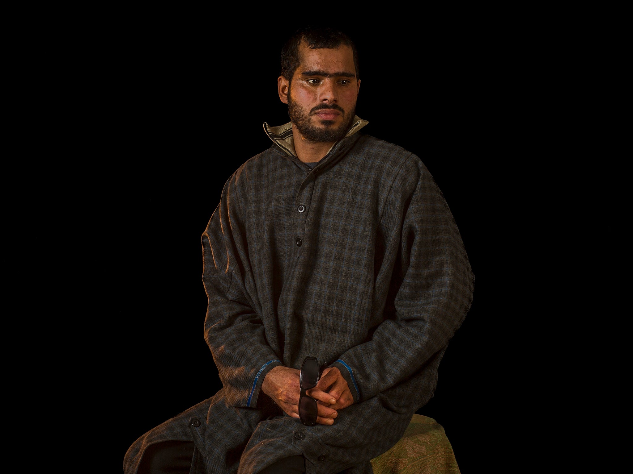 Manzoor Ah-Dar poses for a portrait in Rahmoo, Kashmir. Manzoor was injured in both eyes by metal pellets when Indian forces raided the village