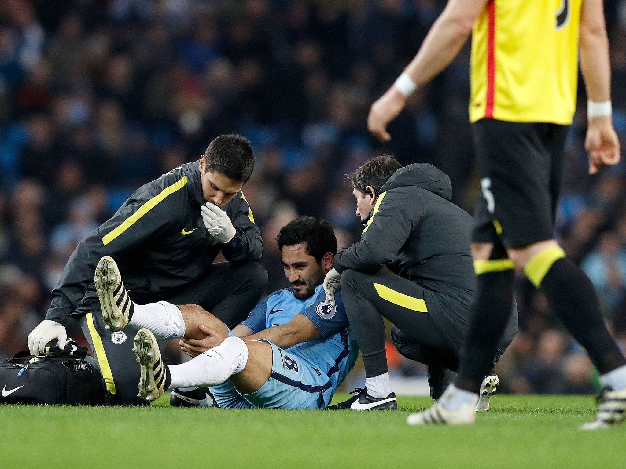 Ilkay Gundogan receives treatment after injuring his knee