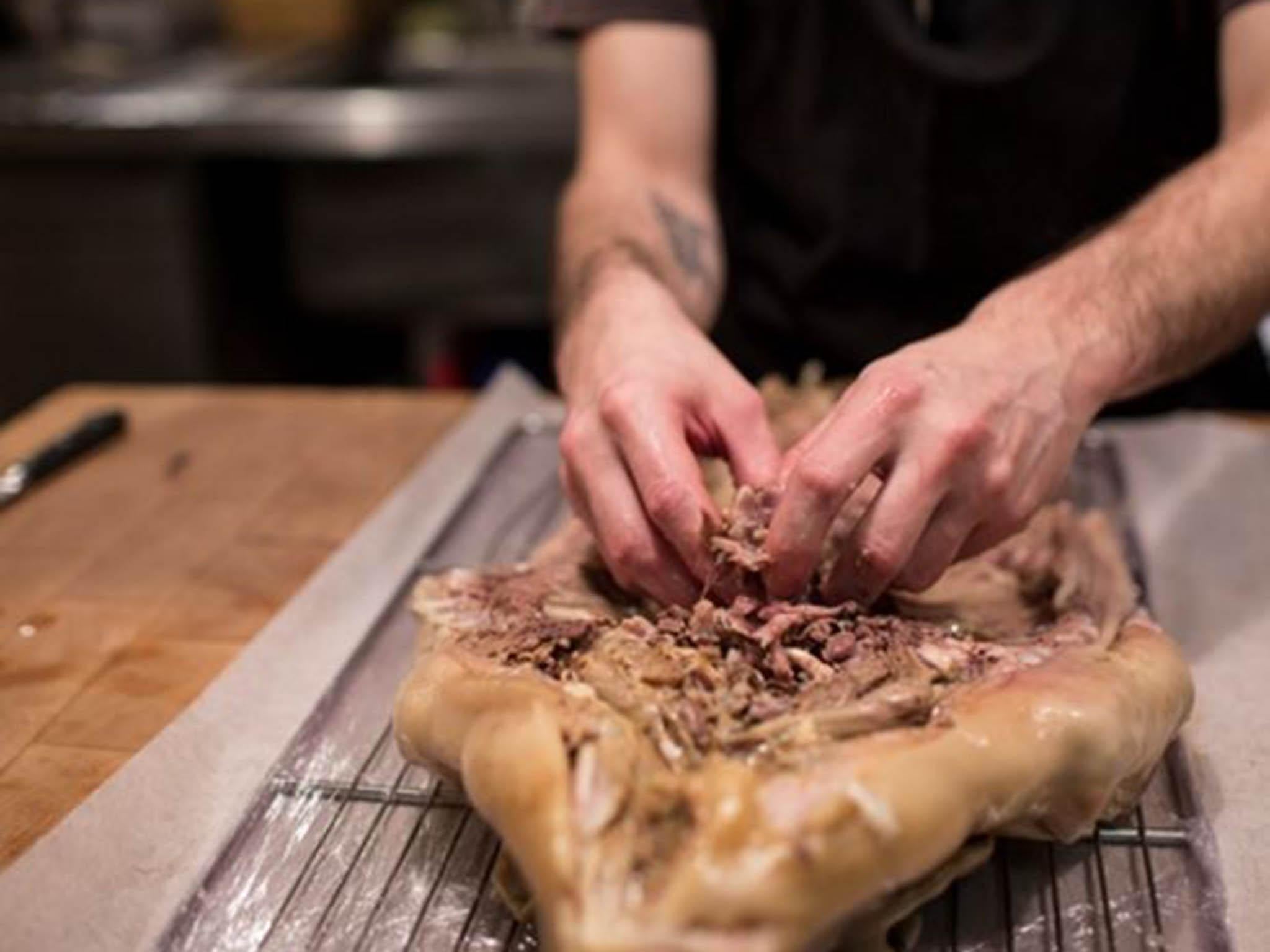 Every single bone is removed from the meat and set aside in a large pot