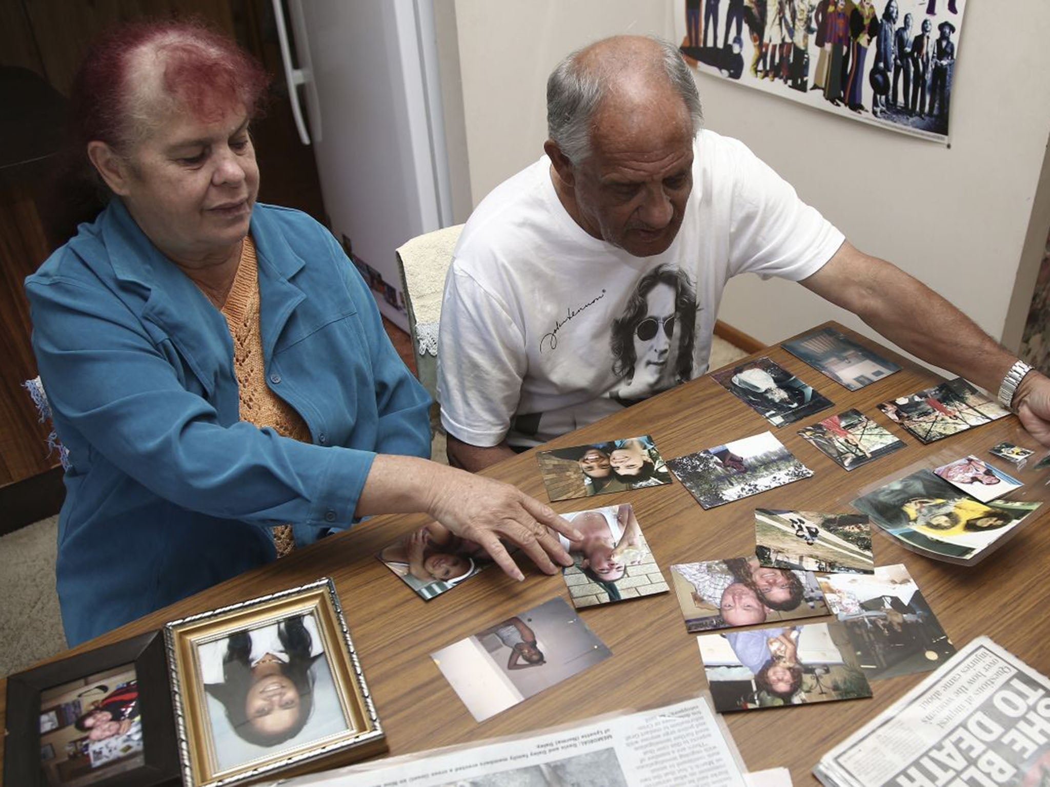 Lynette's parents look at pictures of her at their home in Yamba, Australia