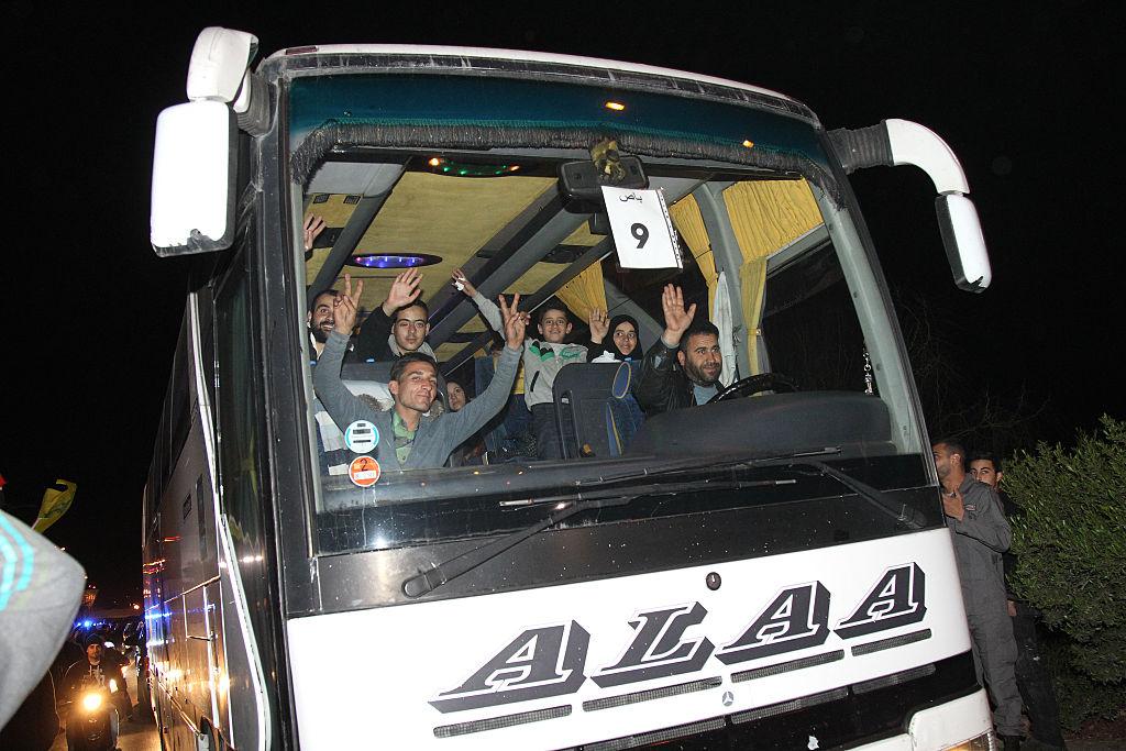 A bus carrying residents from the besieged Syrian towns of Foua and Kefraya leaves Beirut International Airport after a December 2015 truce deal which has since collapsed