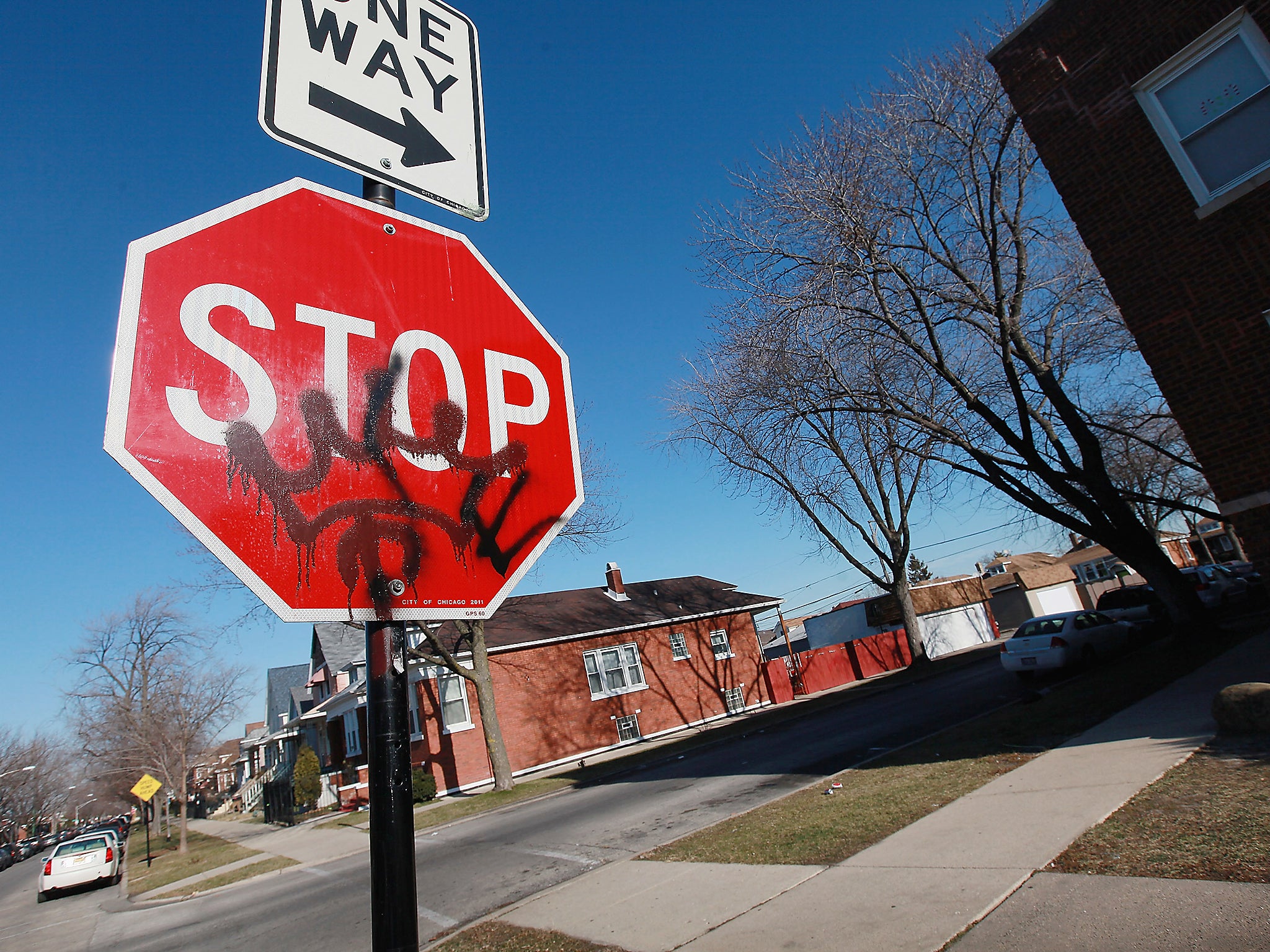 Gang graffiti is painted on a stop sign on the 5800 block of South Sacramento Avenue near the spot where 19-year-old Devonta Grisson was killed in a drive-by shooting on New Year’s Day