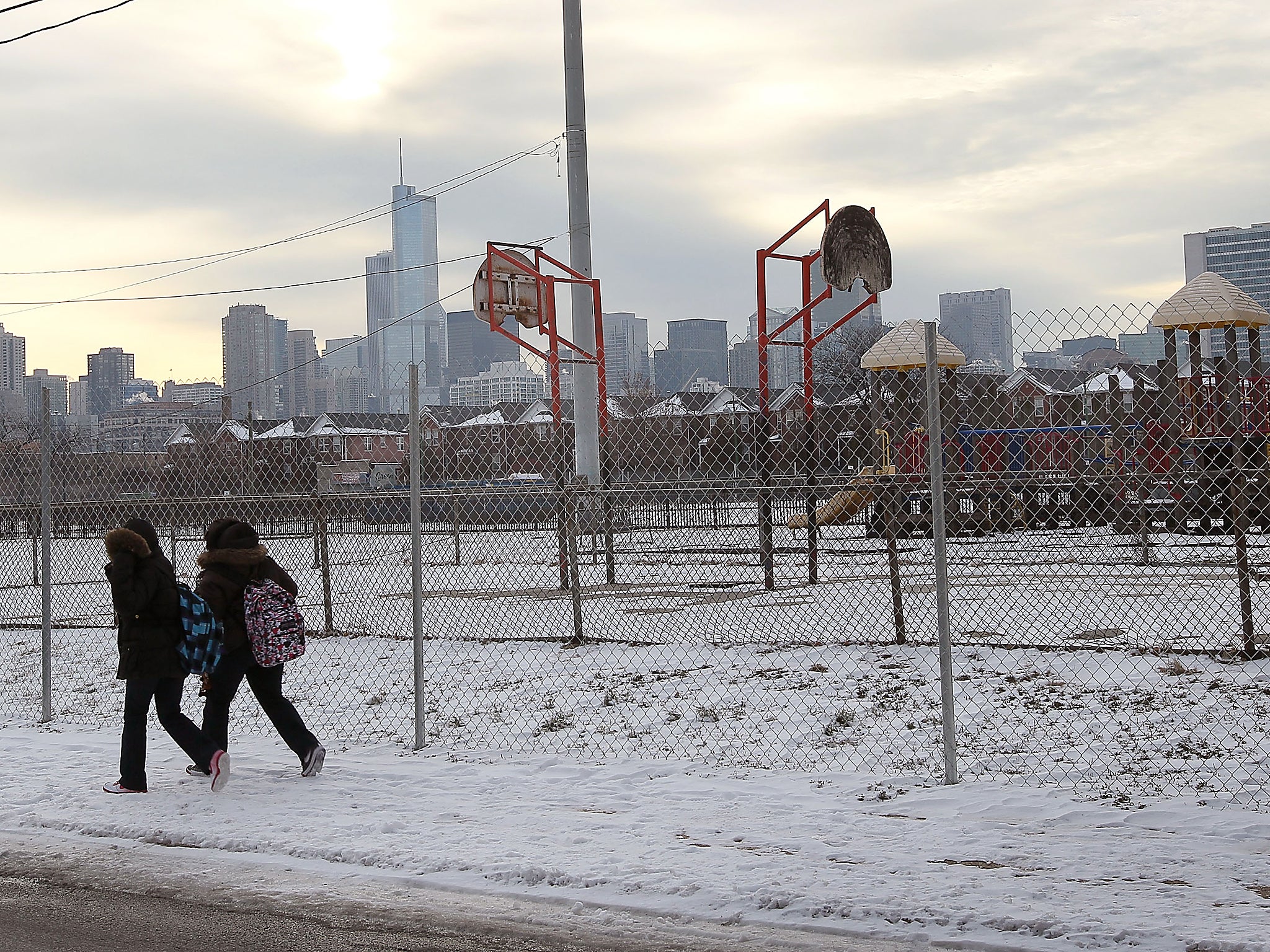 Snow covers the ground outside the only remaining high-rise building in the Cabrini-Green public housing complex as the last family prepares to move out of the building in Chicago, Illinois. The complex once housed 15,000 residents and was notorious for its crime, gangs and drugs