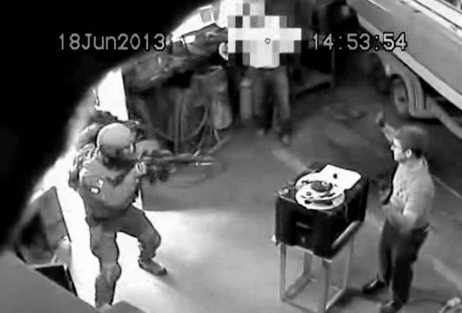 FBI surveillance video showing FBI agents raiding a garage where Glendon Crawford worked