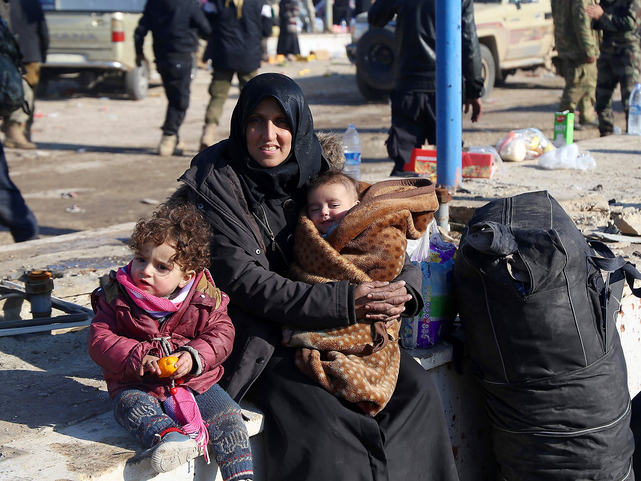 Syrians who were evacuated from the last rebel-held pockets of the northern city of Aleppo, arrive in the opposition-controlled Khan al-Assal