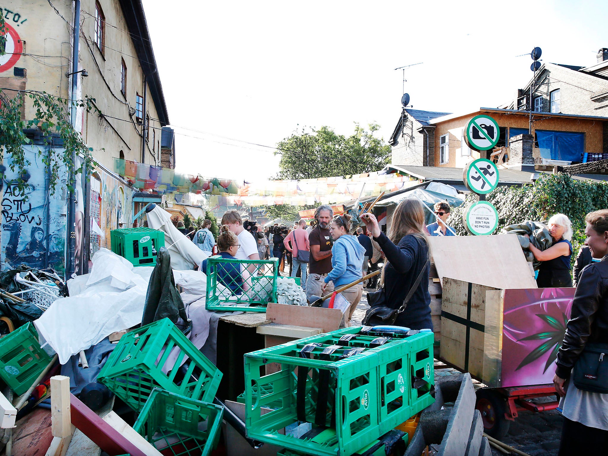 Residents clearing away cannabis market stalls in the Freetown Christiania district of Copenhagen following a shooting in September