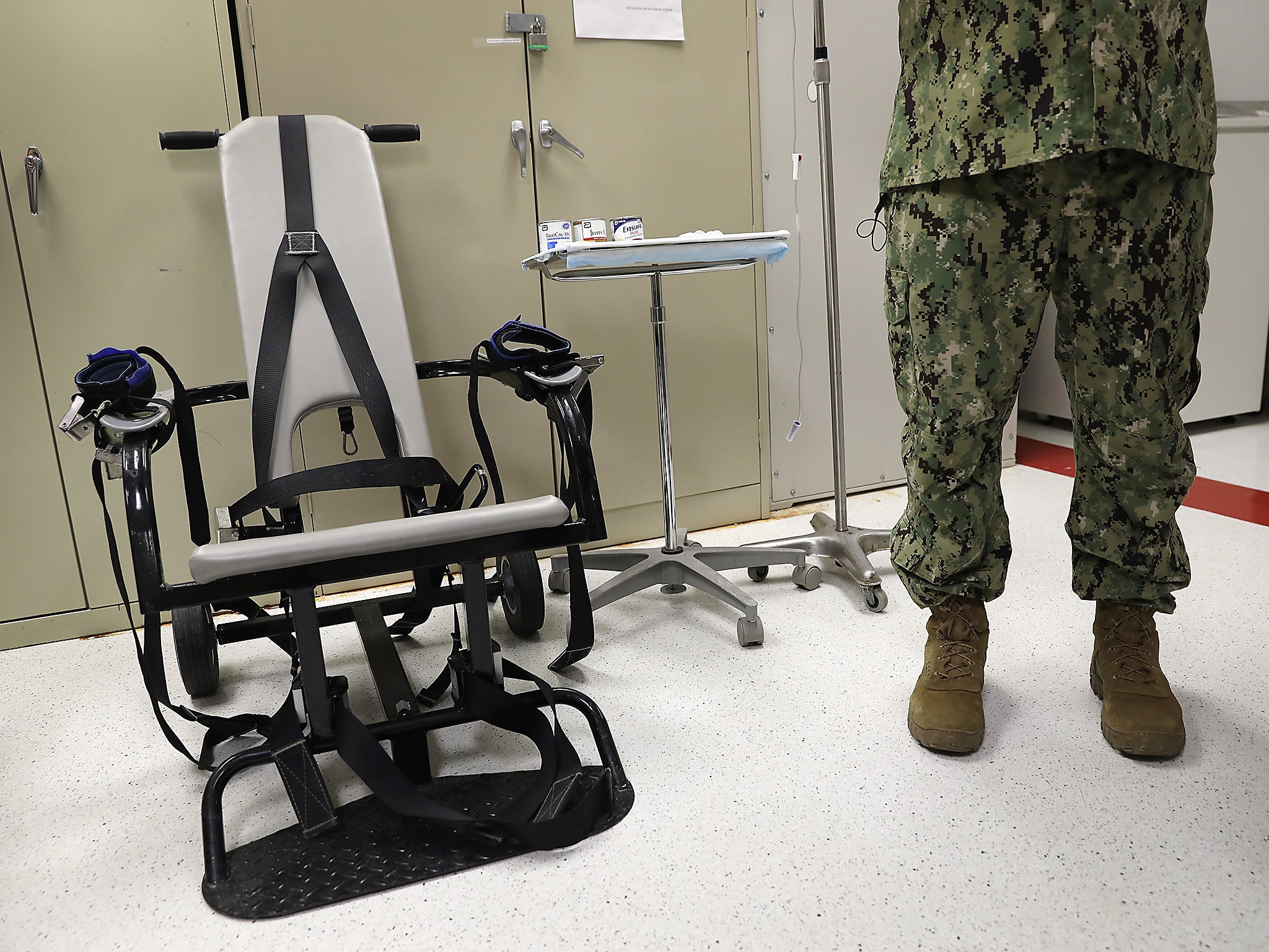 A US Navy doctor displays a restraint chair in the detainee clinic in the 'Gitmo' maximum security detention centre at the US Naval Station at Guantanamo Bay, Cuba