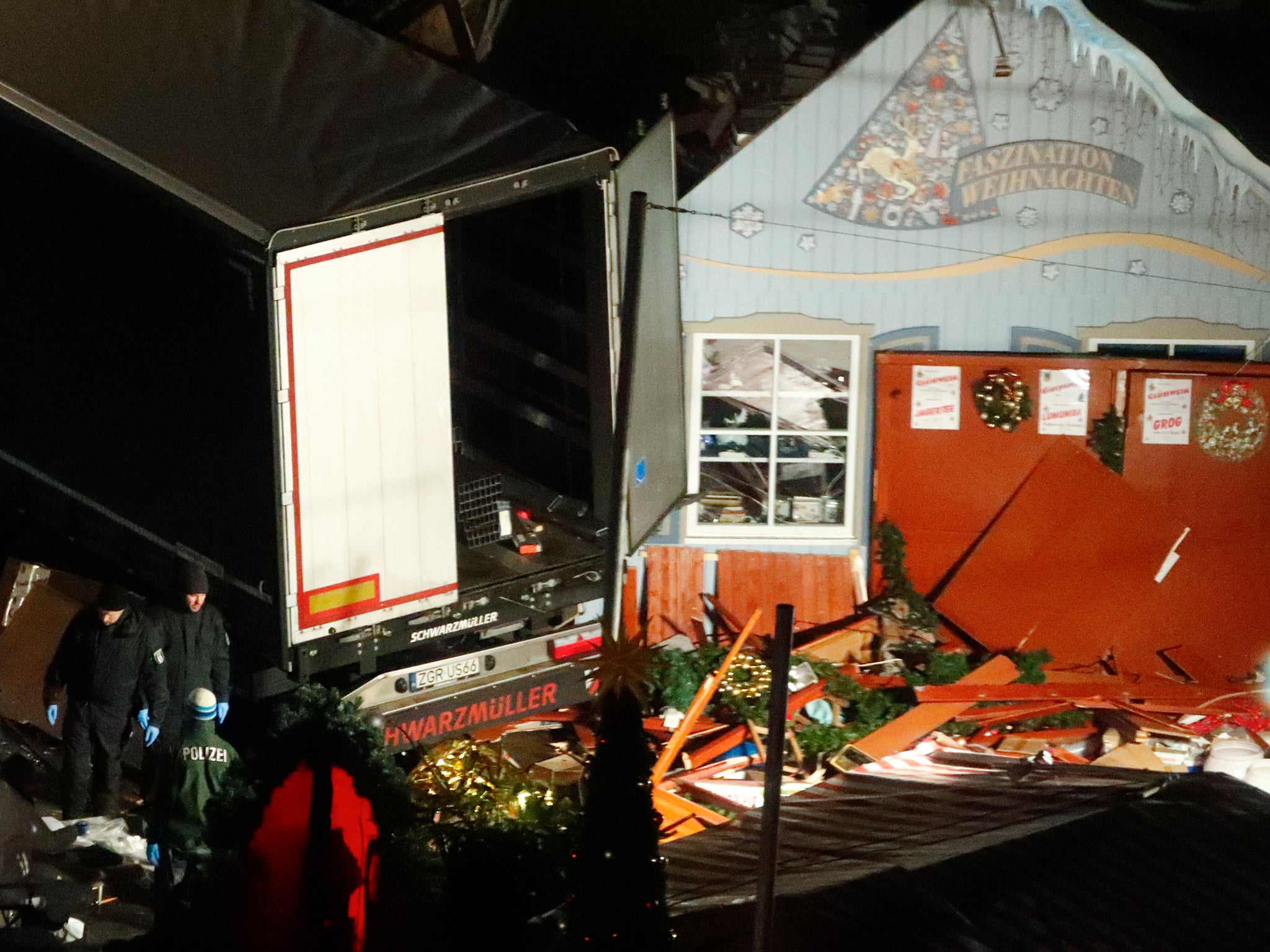 Police investigators inspect a truck that ploughed through a crowd of a Christmas market on Breitscheidplatz square near the fashionable Kurfuerstendamm avenue in the west of Berlin, Germany