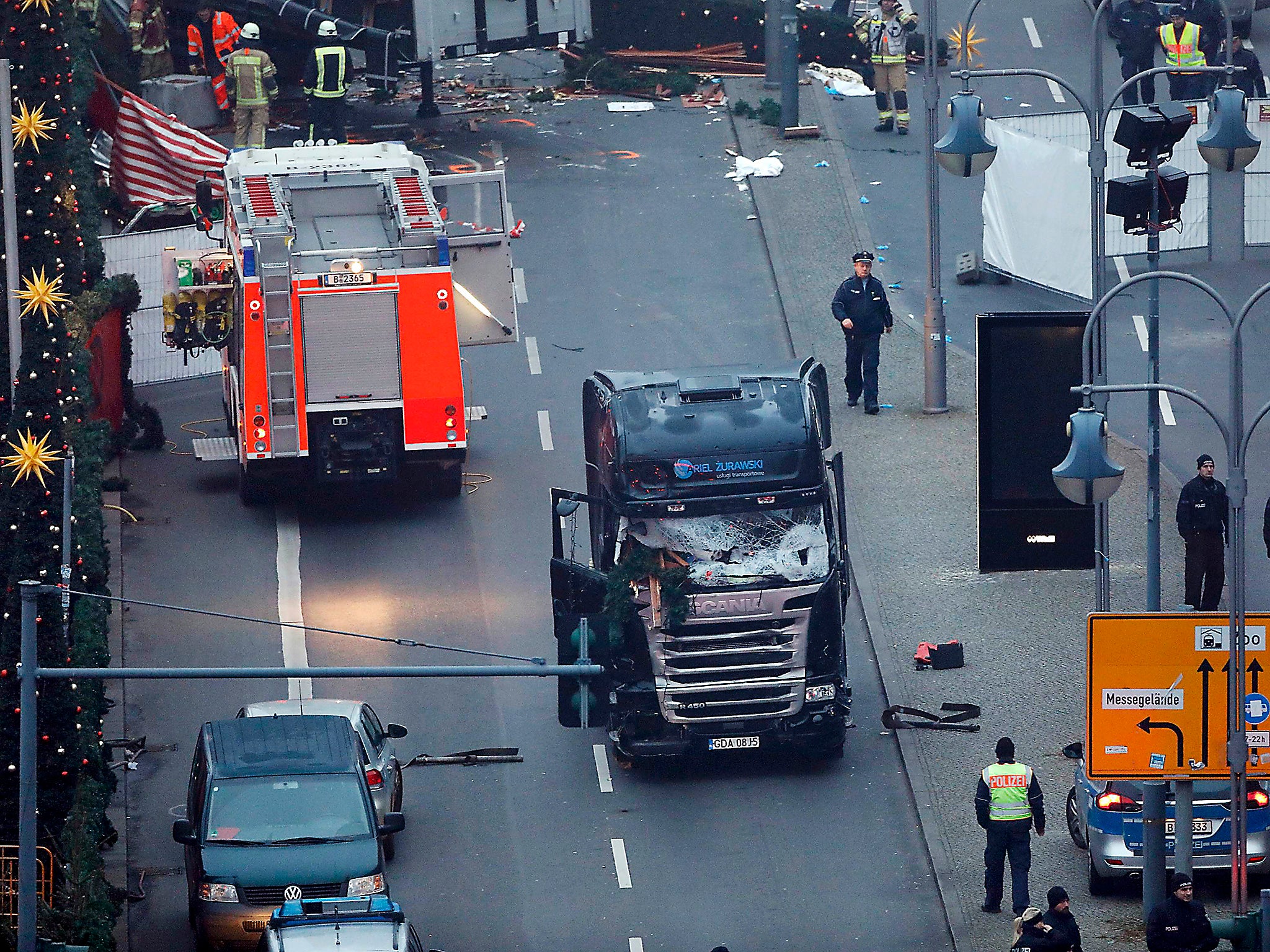 A tow truck operates at the scene where a truck ploughed through a crowd at a Christmas market on Breitscheidplatz square near the fashionable Kurfuerstendamm avenue in the west of Berlin, Germany