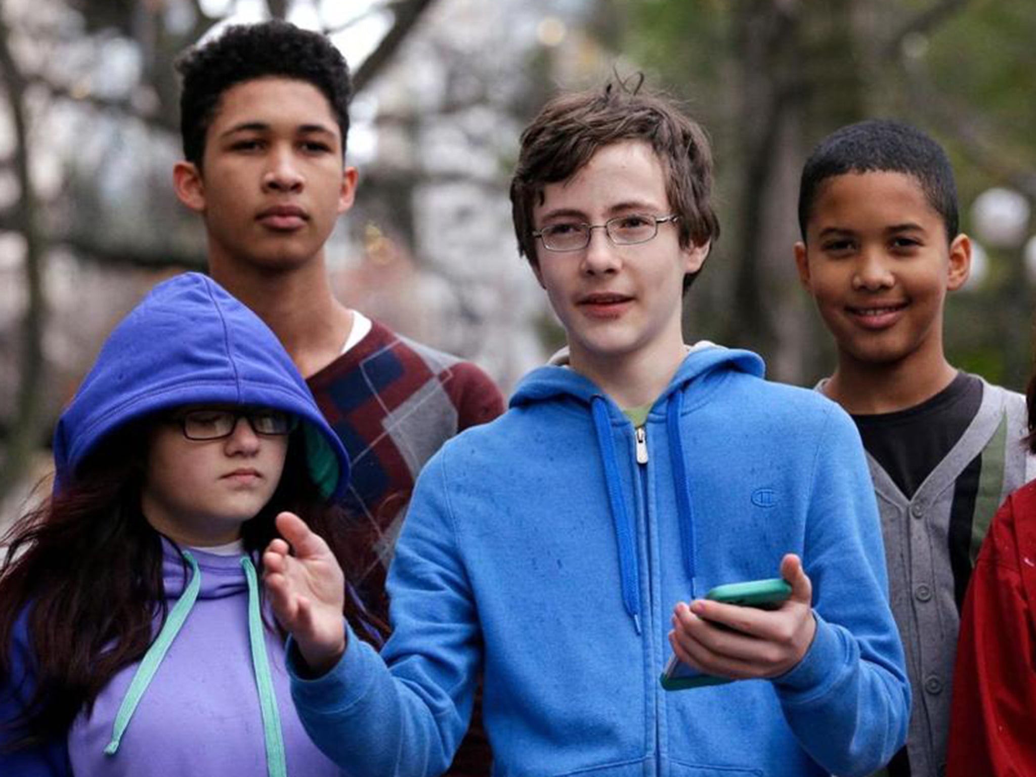 Petitioner Gabe Mandell, centre, 14, addresses media members and supporters as he stands with other children asking Seattle court to force state officials to adopt new rules to limit carbon emissions