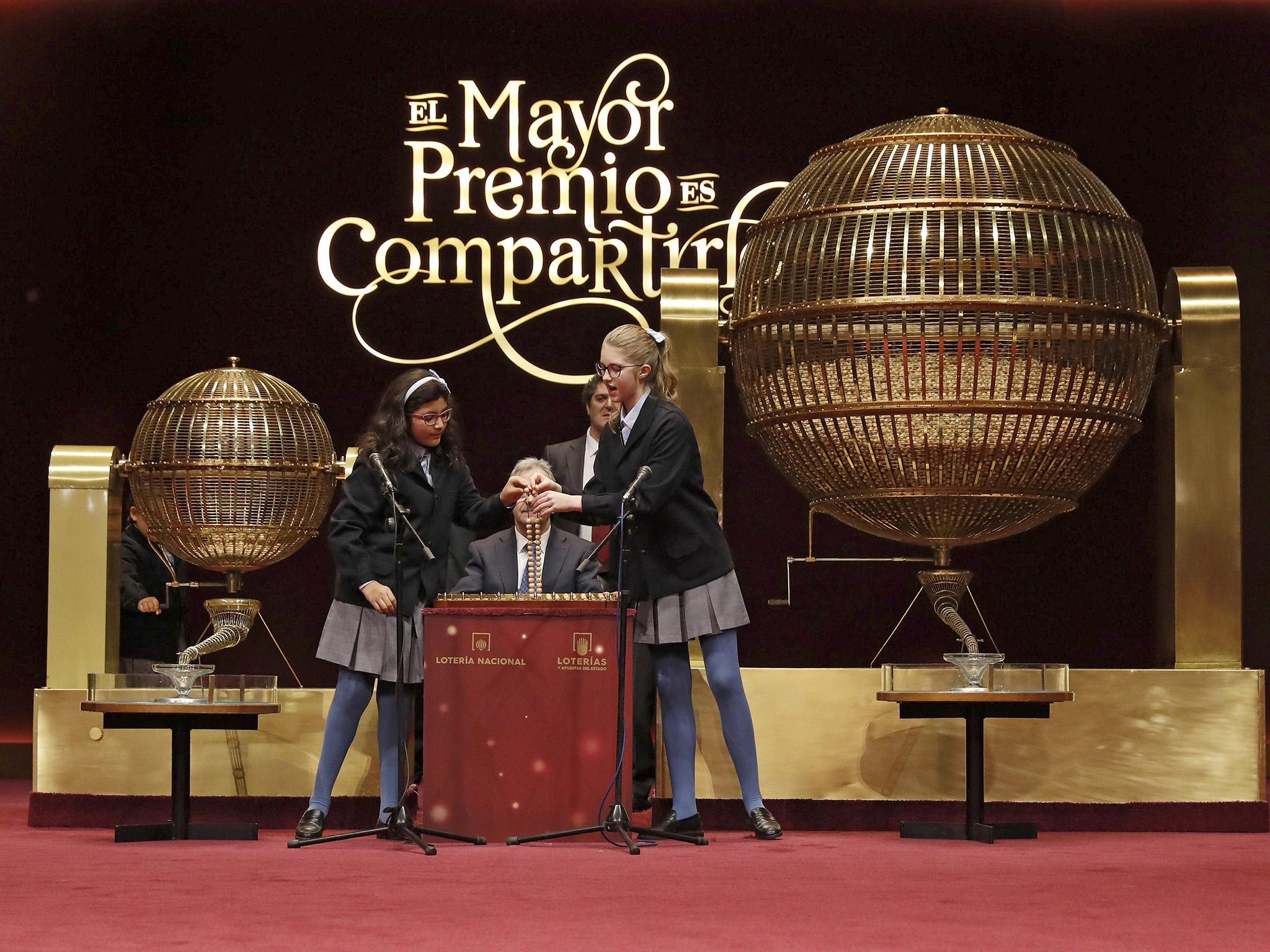 San Idelfonso School students read out the jackpot during El Gordo (The Fat One) lottery draw at the Royal Theatre in Madrid, Spain,