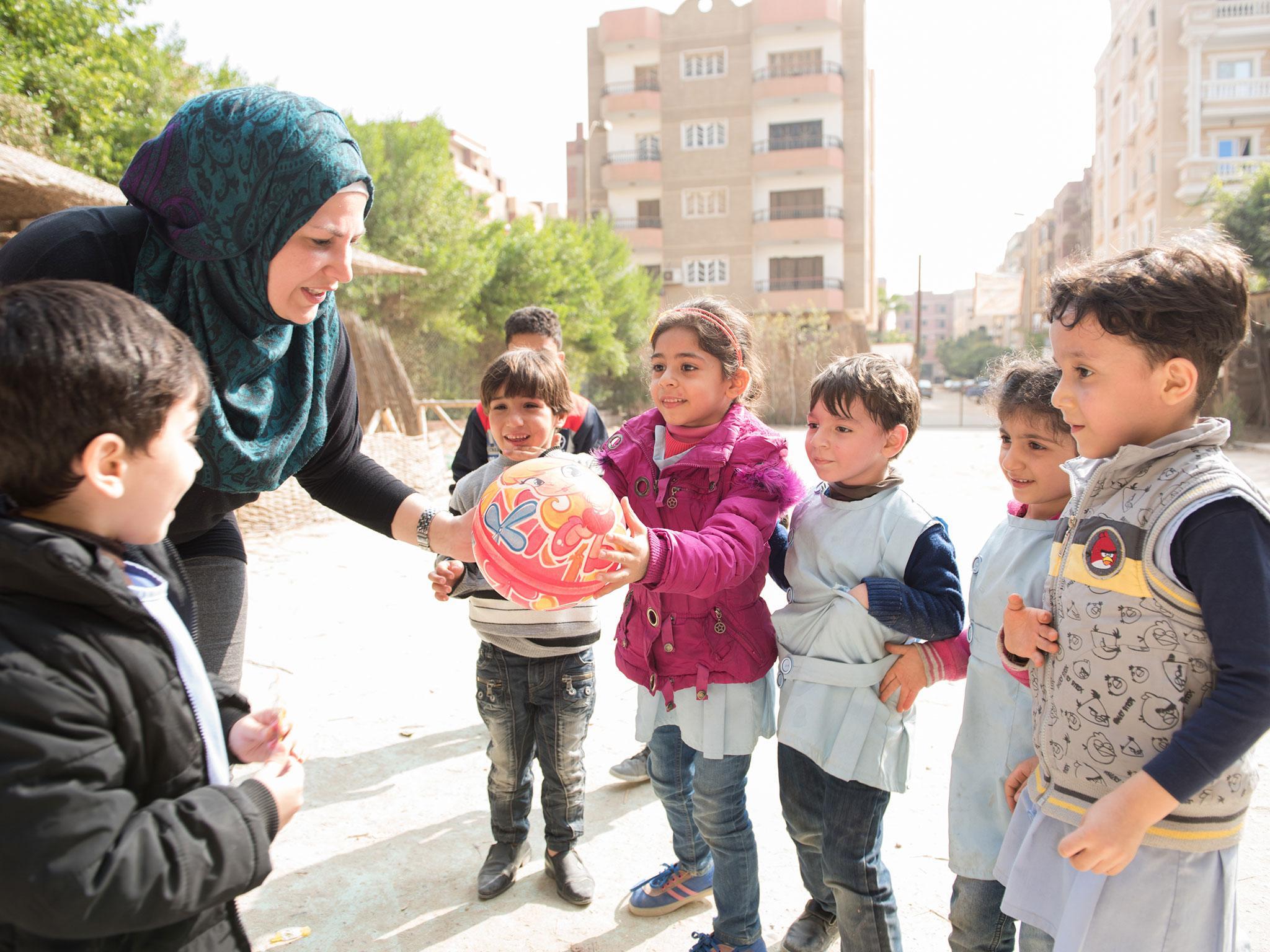 Leen plays with children at the EU-funded Mustaqbalna school in Cairo where she teaches