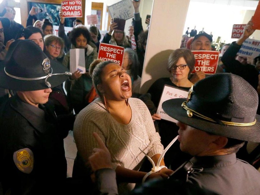 State troopers arrest a protester at the North Carolina statehouse