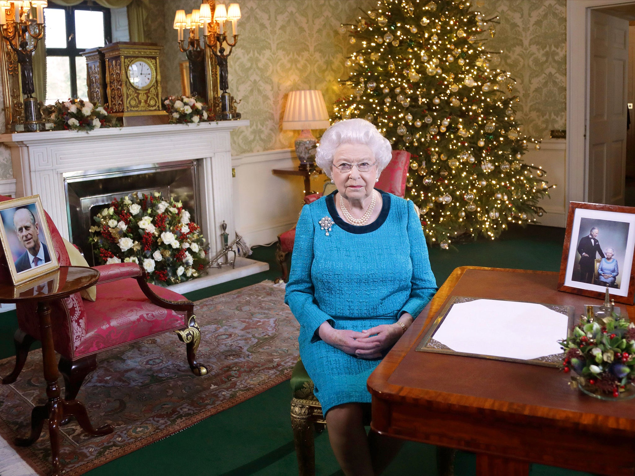 Queen Elizabeth II sits at a desk in the Regency Room in Buckingham Palace, London, after recording her Christmas Day broadcast to the Commonwealth