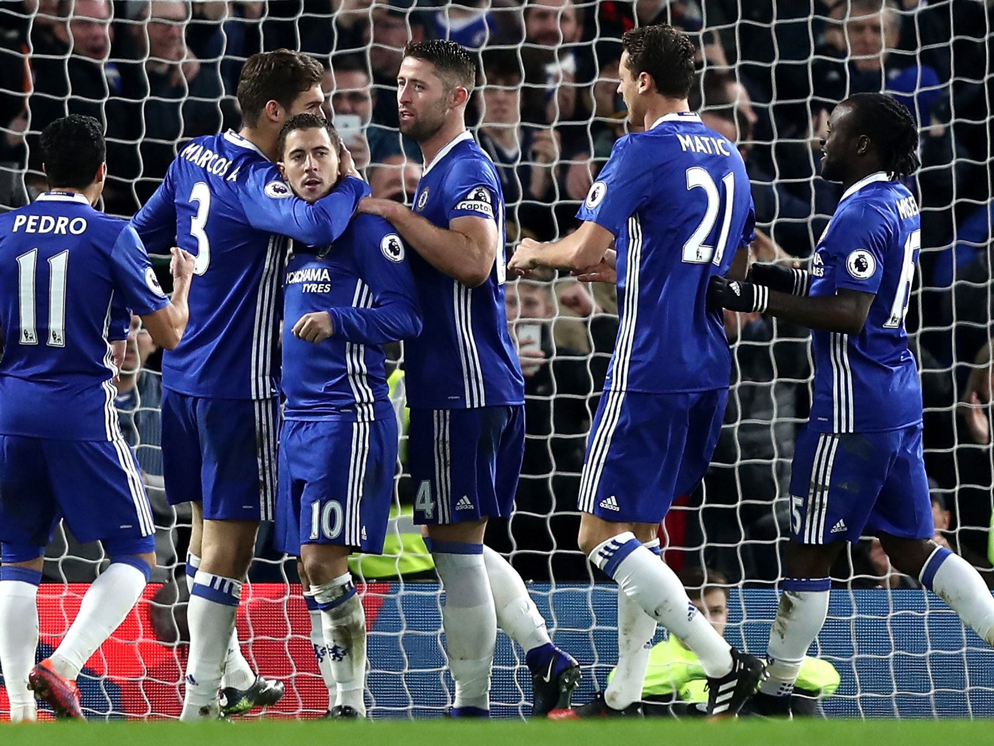 Chelsea players swarm around Hazard after scoring his penalty