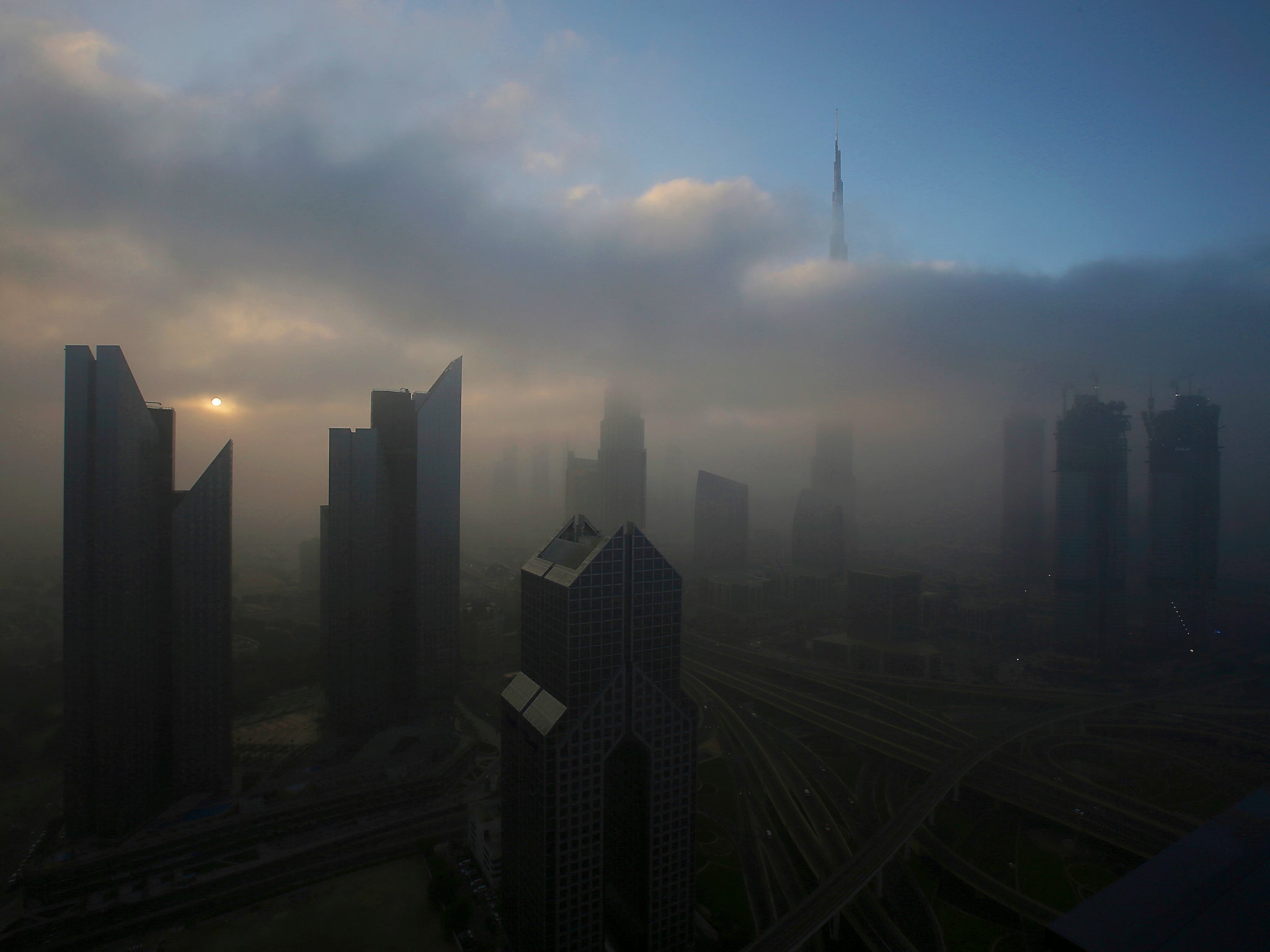 The sun rises over the skyline of Dubai