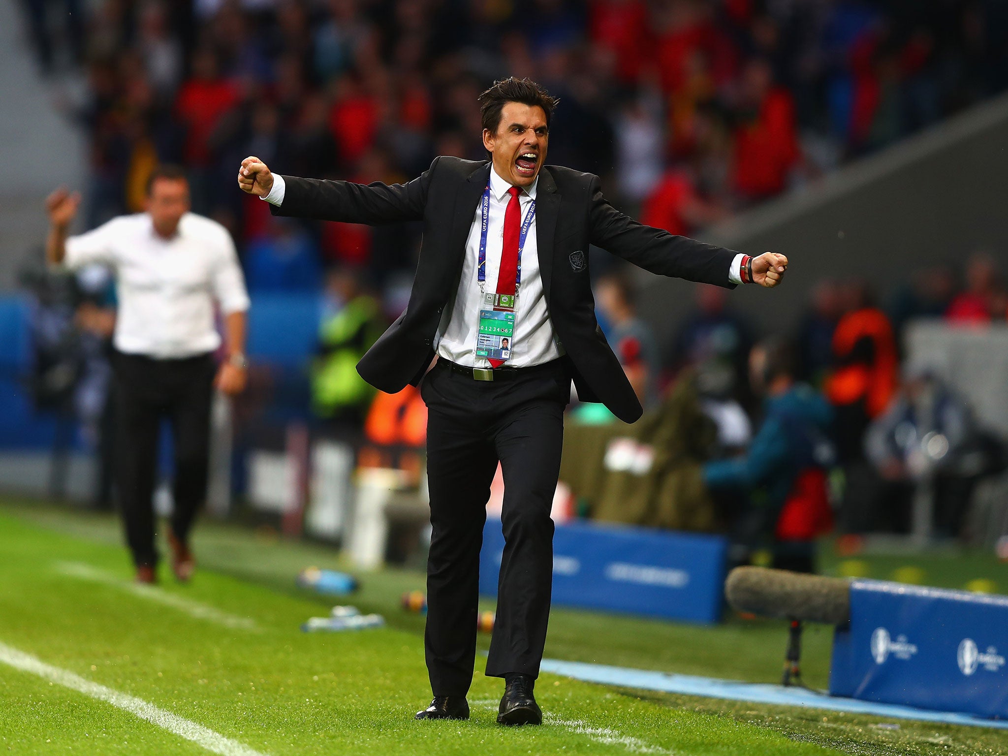 Chris Coleman celebrates on the sideline during Wales' historic victory over Belgium at Euro 2016