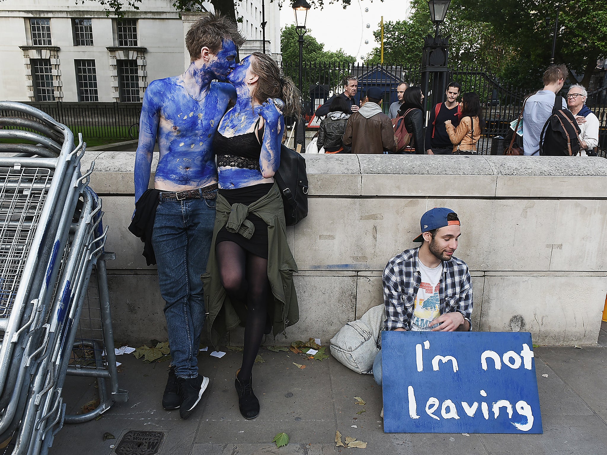 A young couple painted as EU flags, protest outside Downing Street against the decision to leave the EU