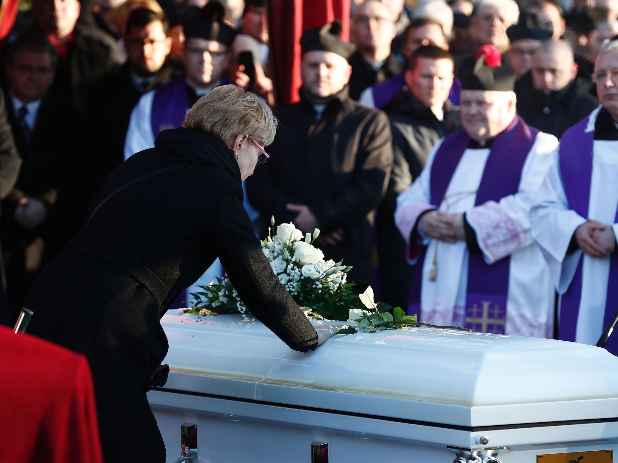 The wife of Lukasz Urban, the Polish lorry driver who was killed in the Berlin Christmas market attack, during his funeral in Banie, Poland, on 30 December