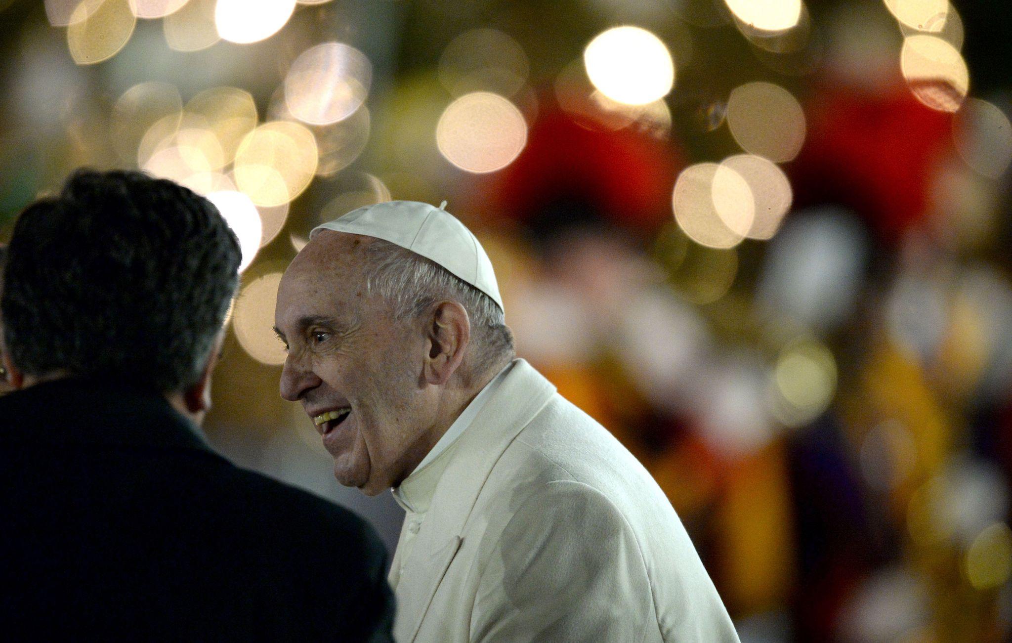 Pope Francis smiles as he visits the traditional Crib in St Peter's Square at the Vatican on December 31, 2016