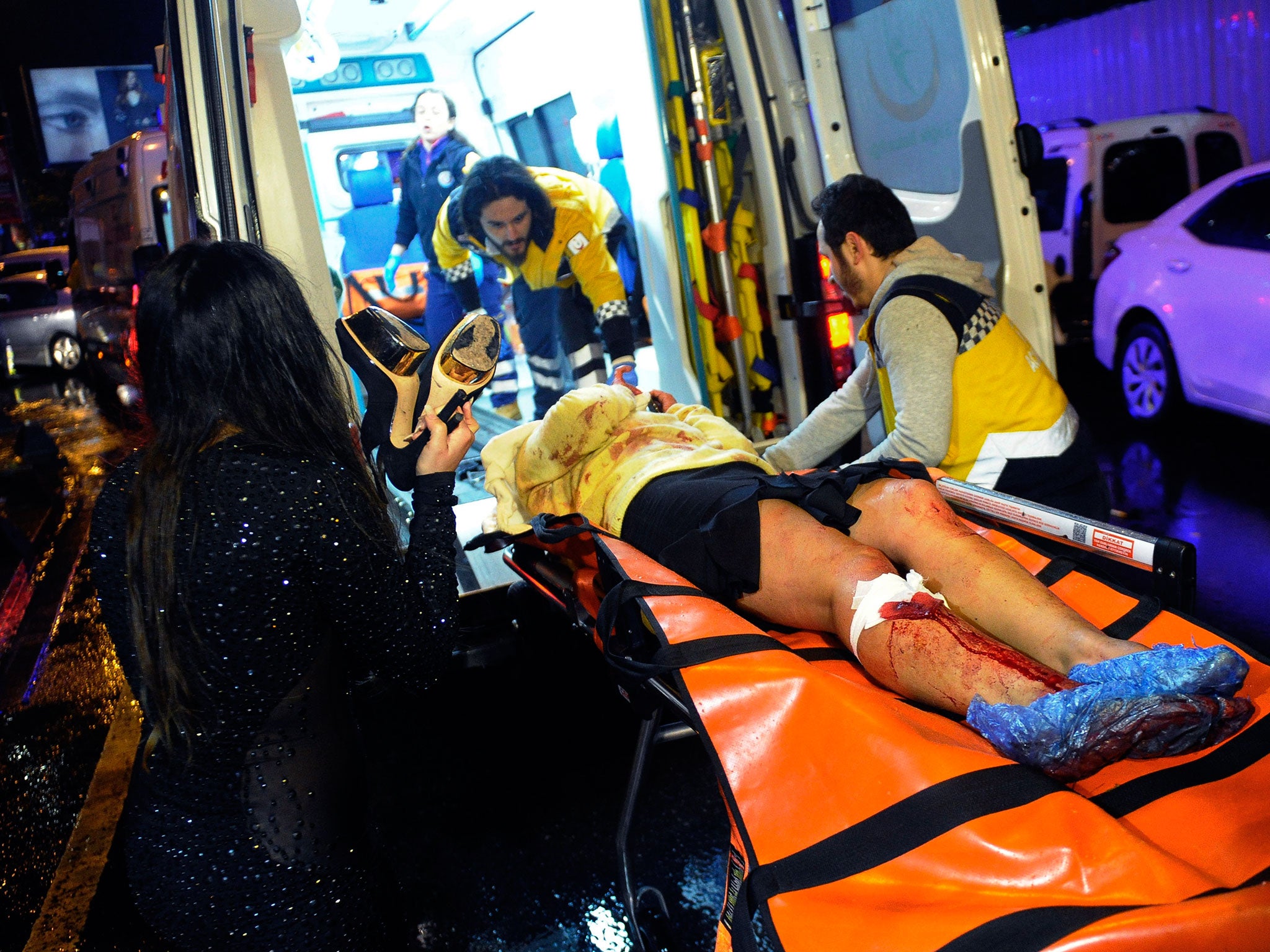 Medics carry a wounded person after an attack at a popular nightclub in Istanbul