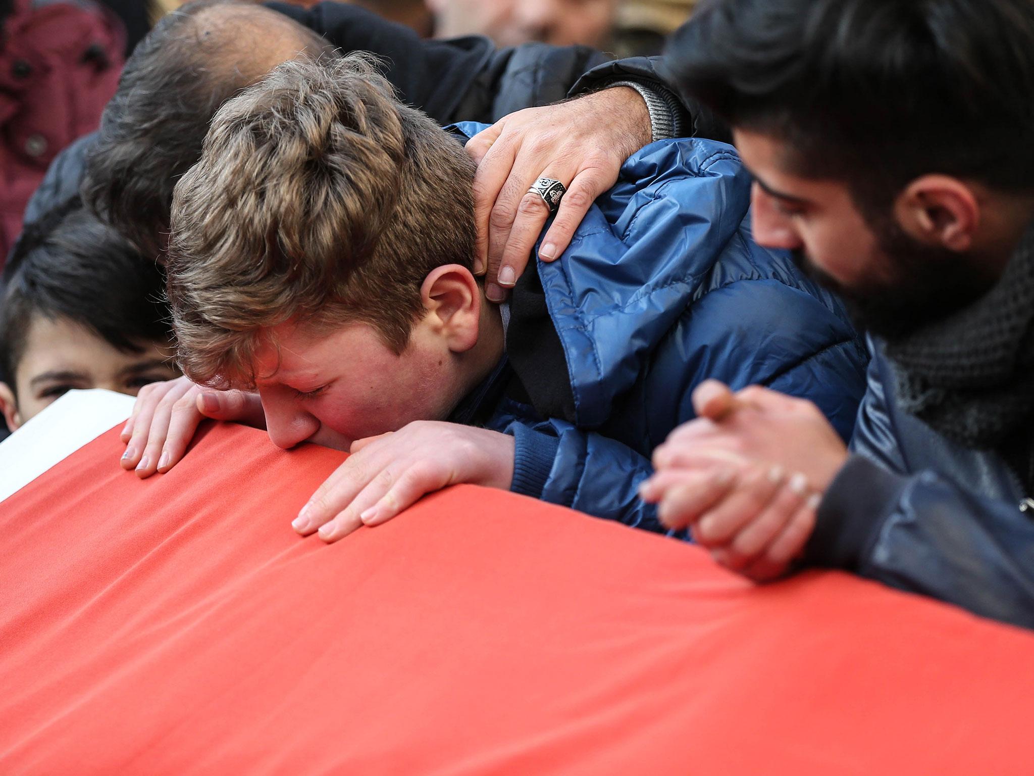 The shooting killed 39 people, including Ayhan Arik, whose funeral is pictured