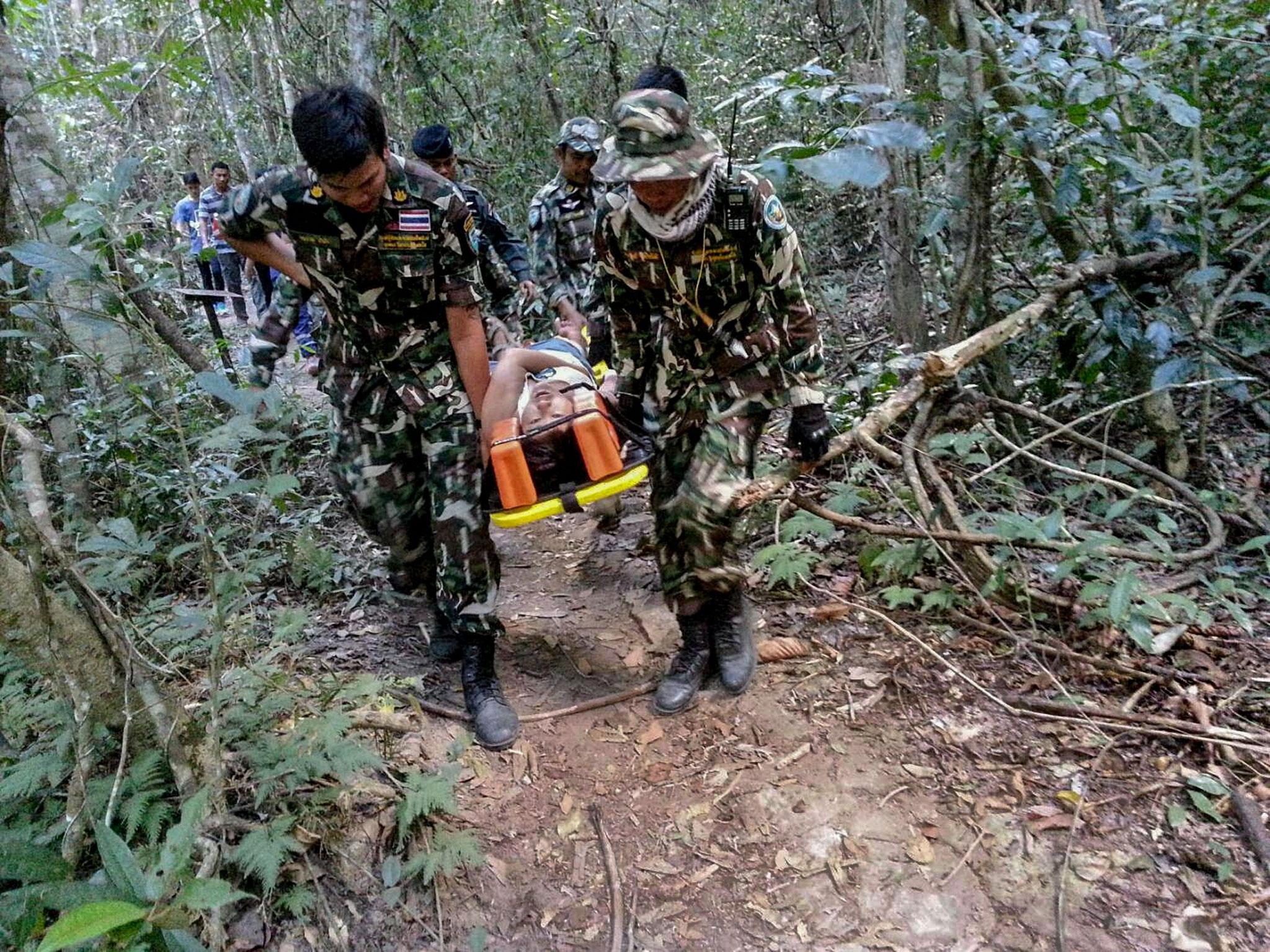 Muriel Benetulier is transported on a stretcher by Thai Park Rangers after she was bitten by after she was bitten by a crocodile