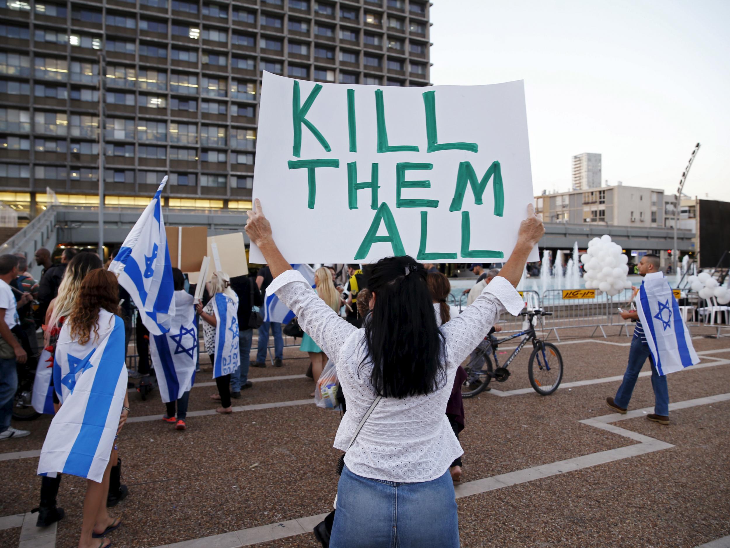 A supporter of Elor Azaria, an Israeli soldier charged with manslaughter by the Israeli military after he shot a wounded Palestinian assailant as he lay on the ground holds a placard during a protest calling for his release