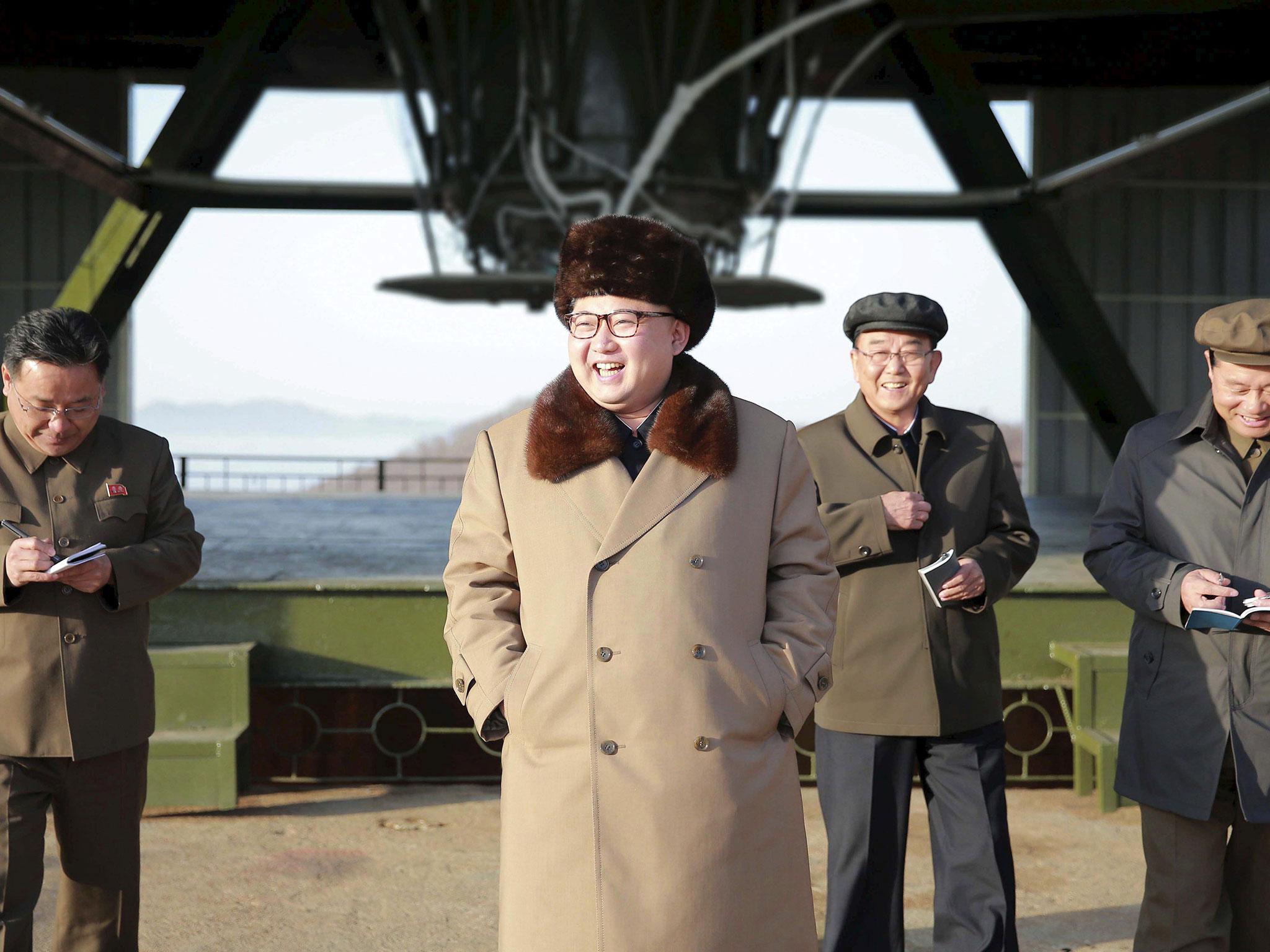 North Korea leader Kim Jong Un smiles as he visits Sohae Space Center for the testing of a new engine for an intercontinental ballistic missile