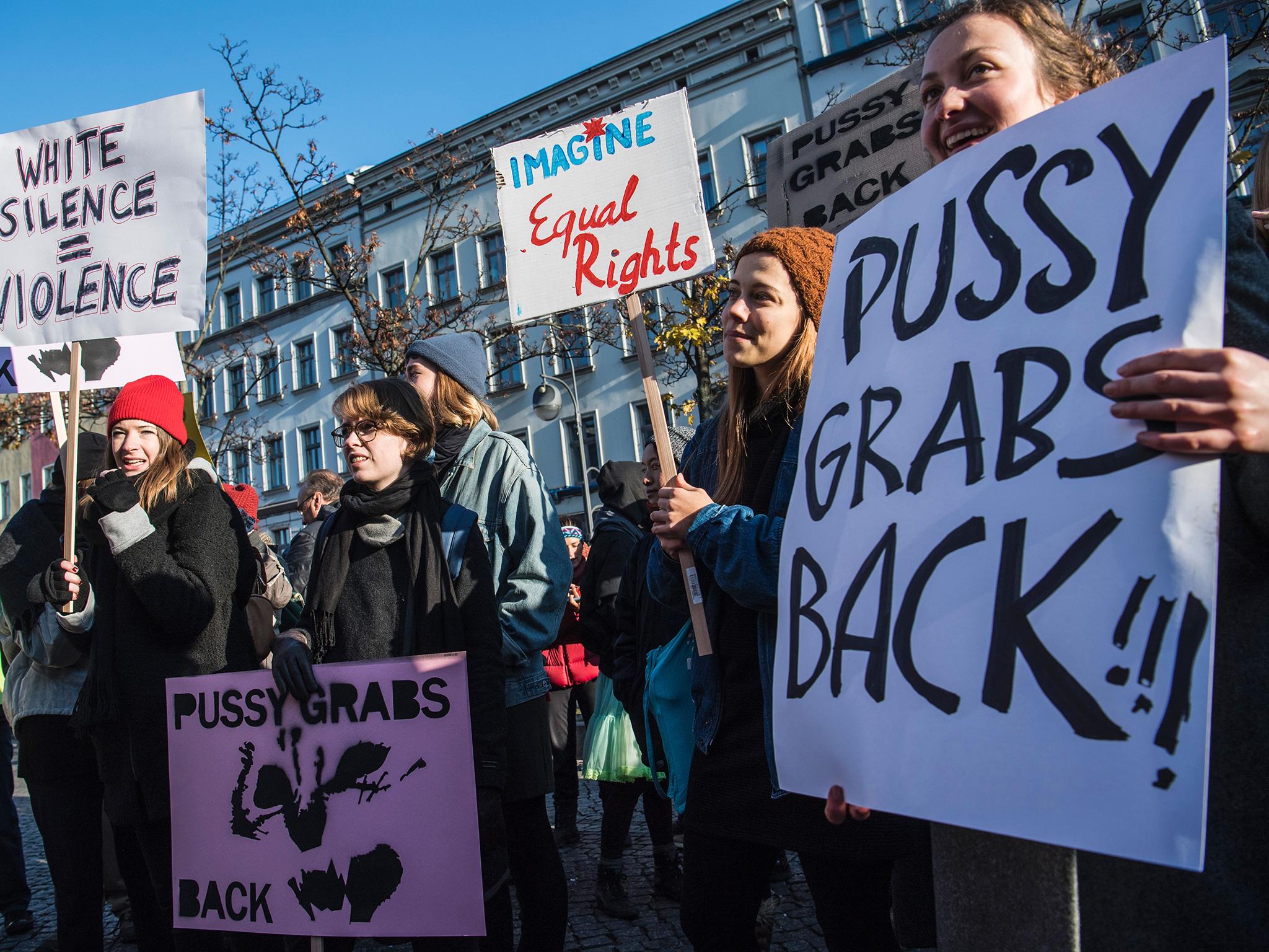 Demonstrators protesting against President-elect Trump display placards during a so-called ‘Pussy Grabs Back’ demonstration in Berlin