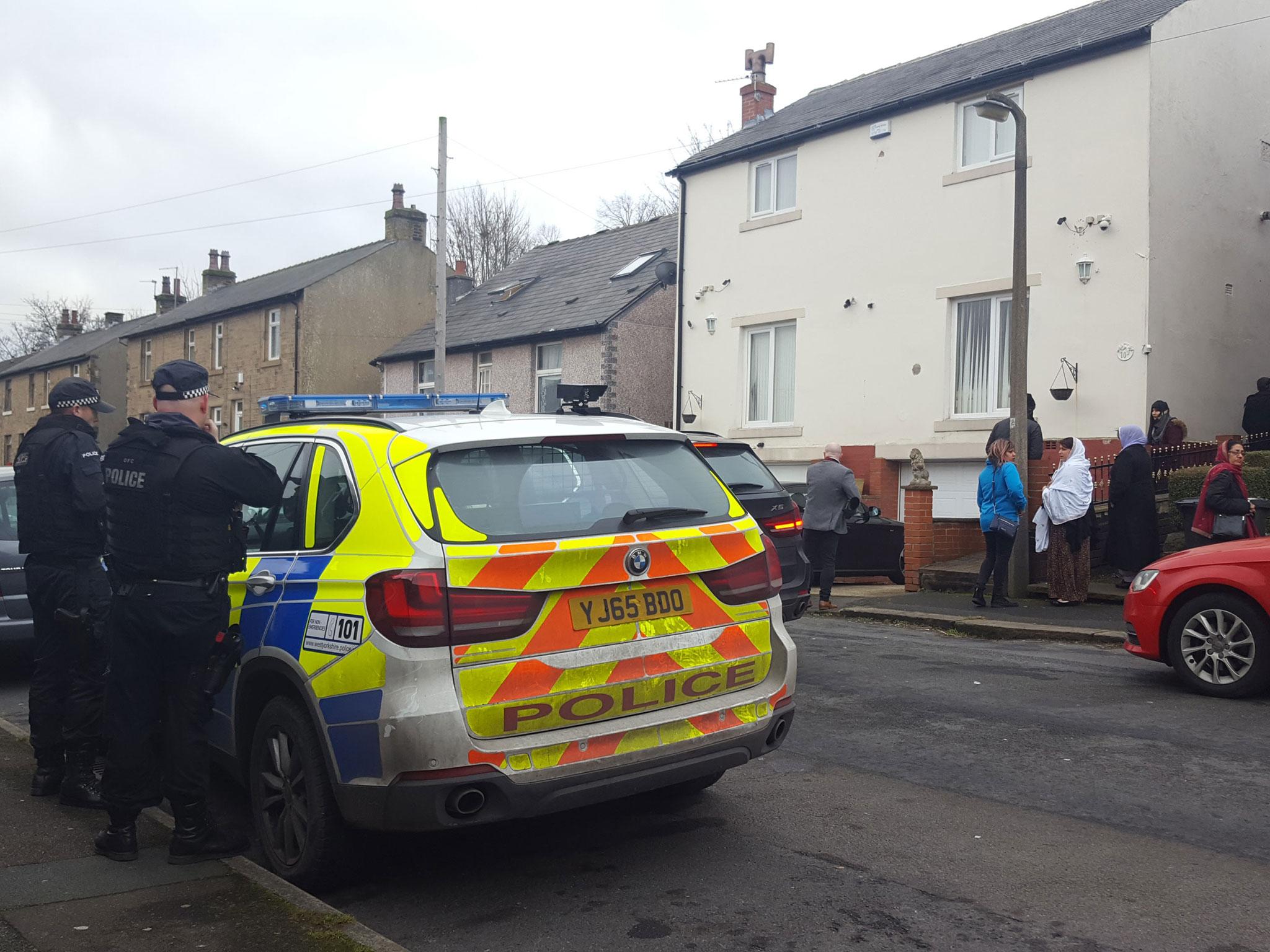 Armed police officers arrive at the home of Mohammed Yassar Yaqub in the Crosland Moor area of Huddersfield