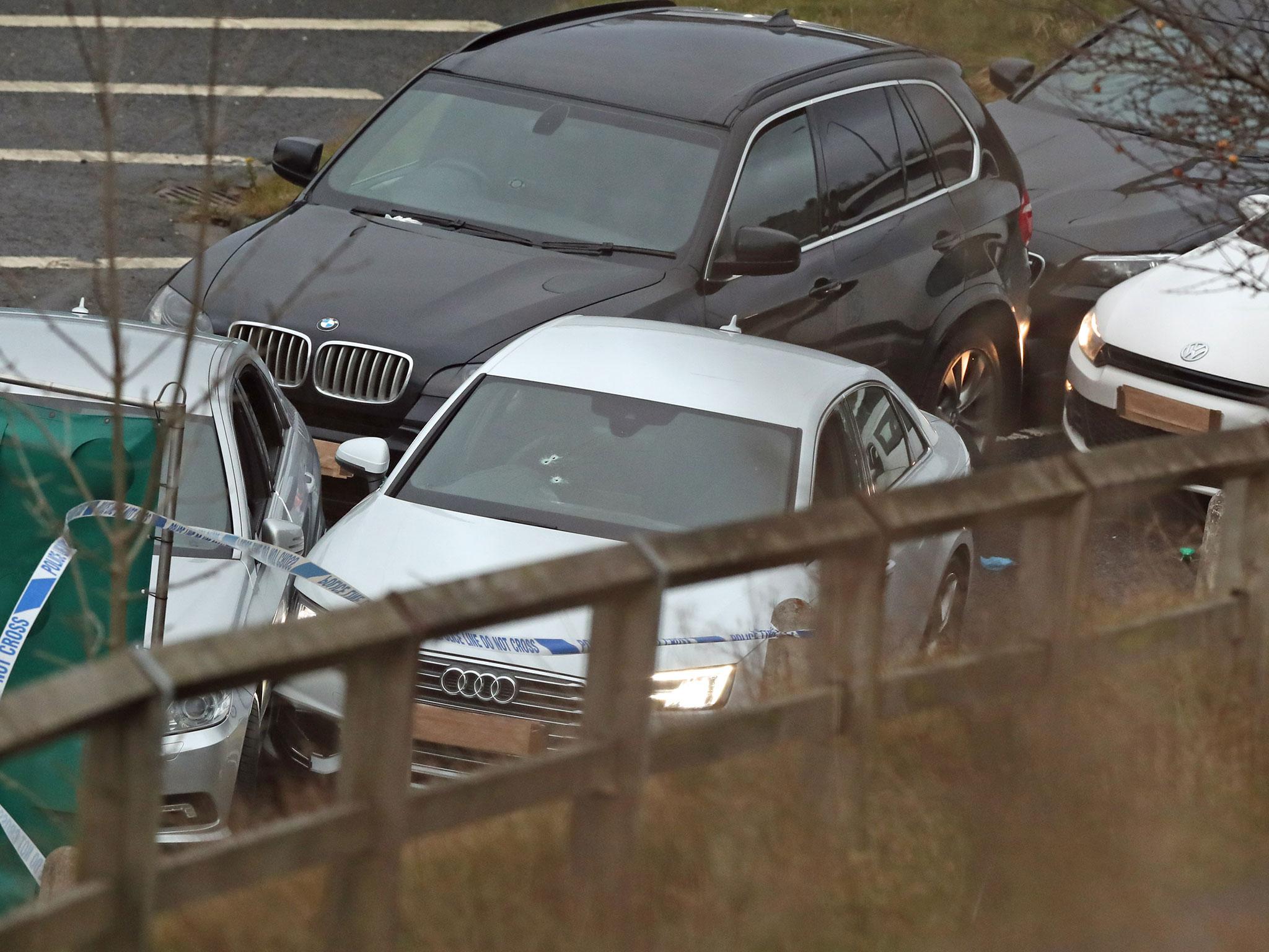 A silver Audi with bullet holes in its windscreen at the scene near junction J24 of the M62 in Huddersfield