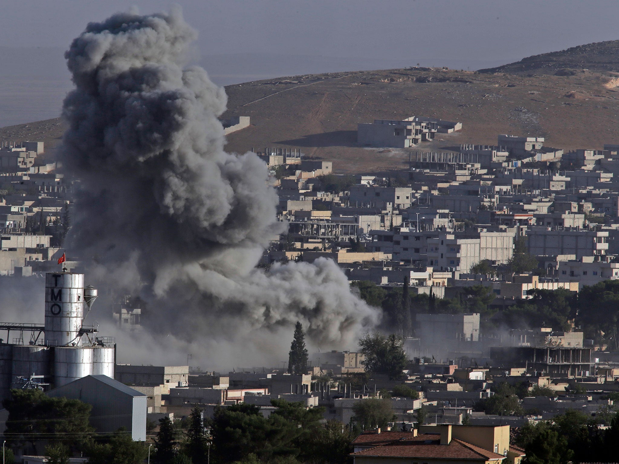 Smoke rises following an air strike by the US-led coalition in Kobani, Syria, during fighting between Kurds and Isis in October 2014