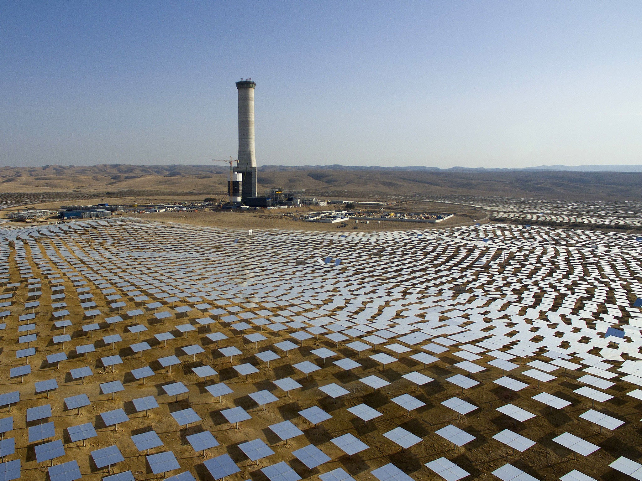 In this 22 December 2016 photo, 50,000 mirrors - known as heliostats - encircle the solar tower in the Negev desert, near in Ashelim, southern Israel