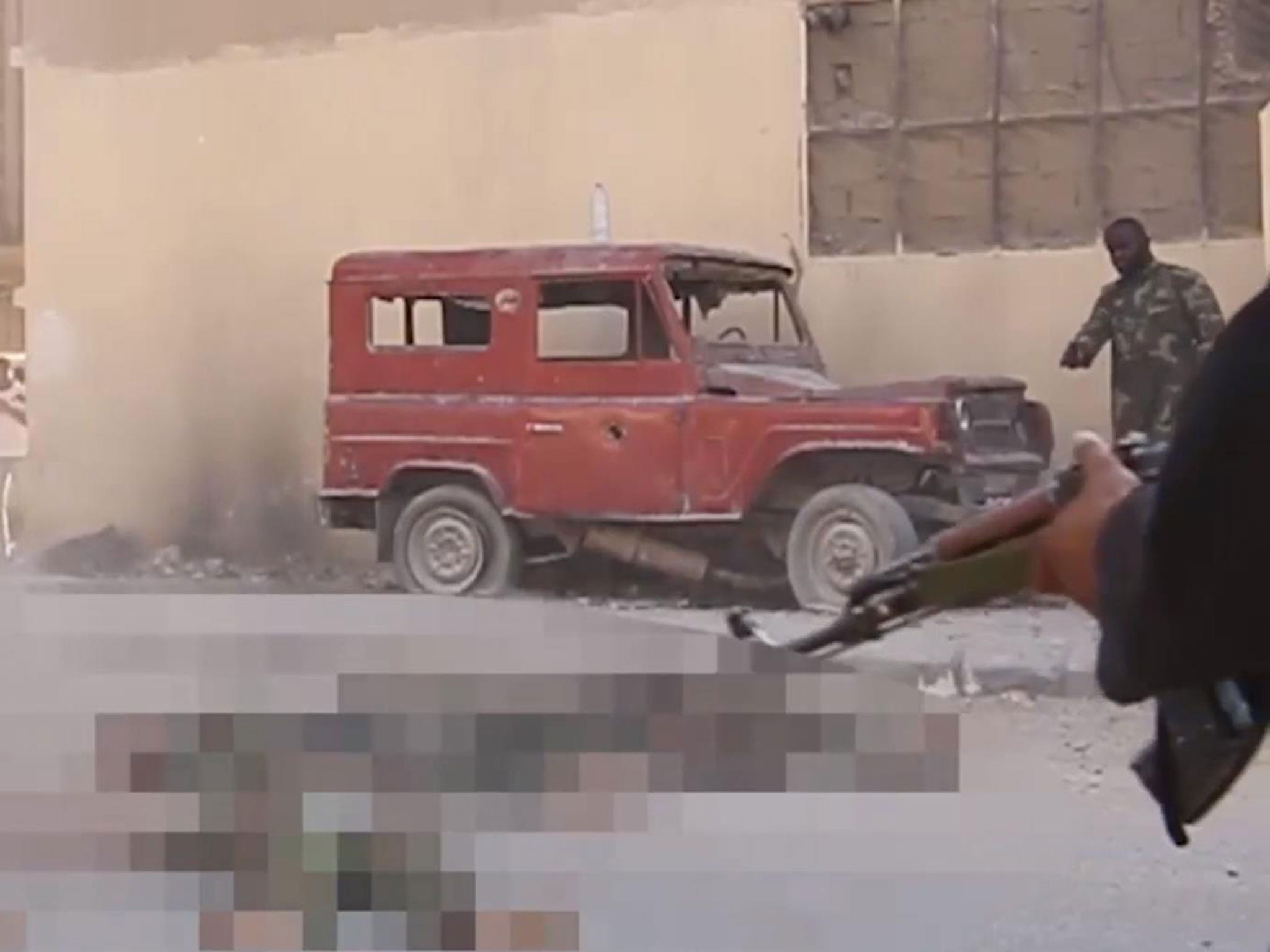 Harry Sarfo (top right) was seen pointing a gun towards captives during an Isis execution in Palmyra, Syria, in June 2015