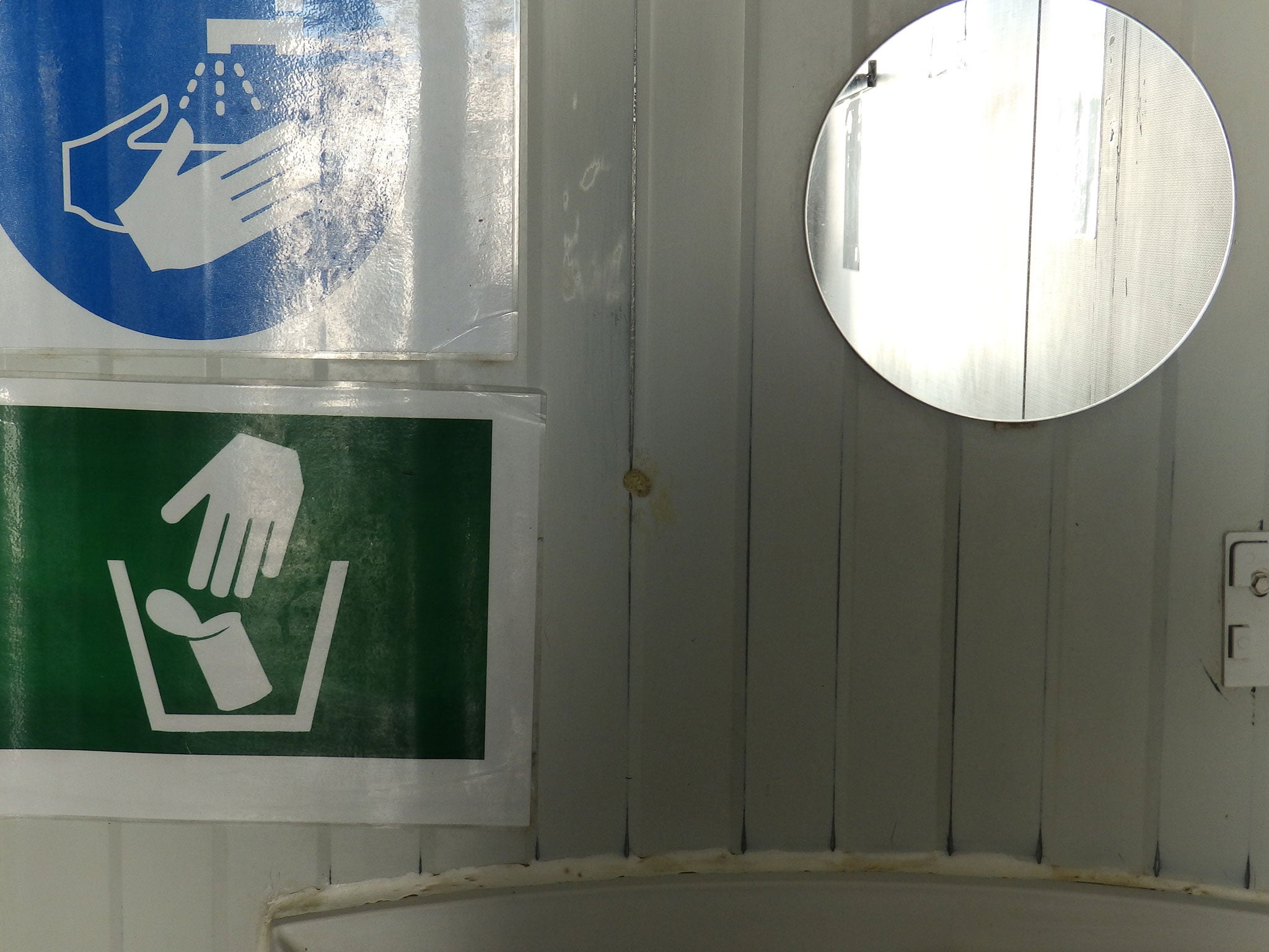 A repaired hole from a bullet fired by the Libyan coastguard in a bathroom used by refugees on MSF ship the Bourbon Argos