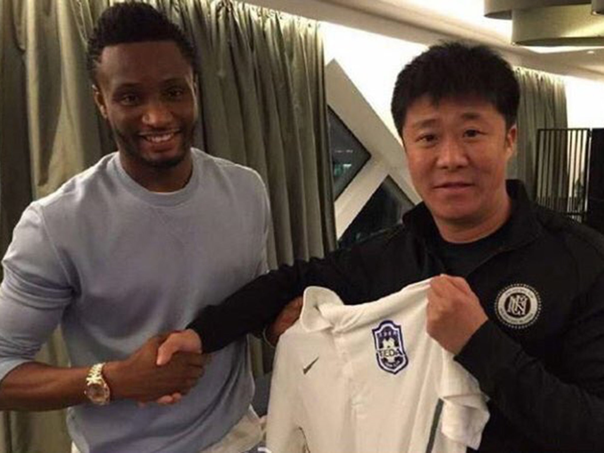John Obi Mikel was pictured shaking hands with Tianjin official on social media